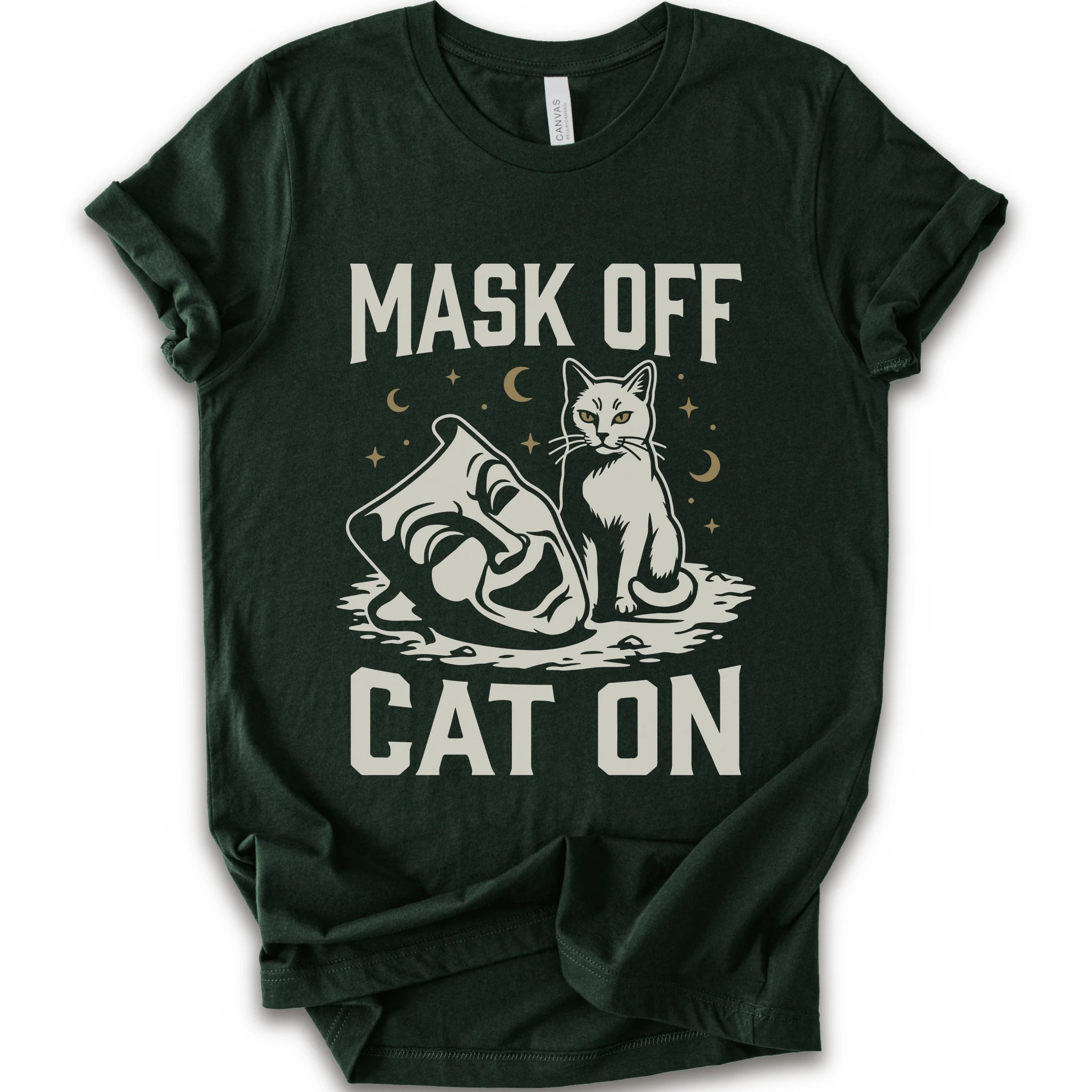 A forest short-sleeve crewneck t-shirt with a white graphic with gold moons and stars of a cat with a mask surrounded by the text 'MASK OFF' and 'CAT ON'.