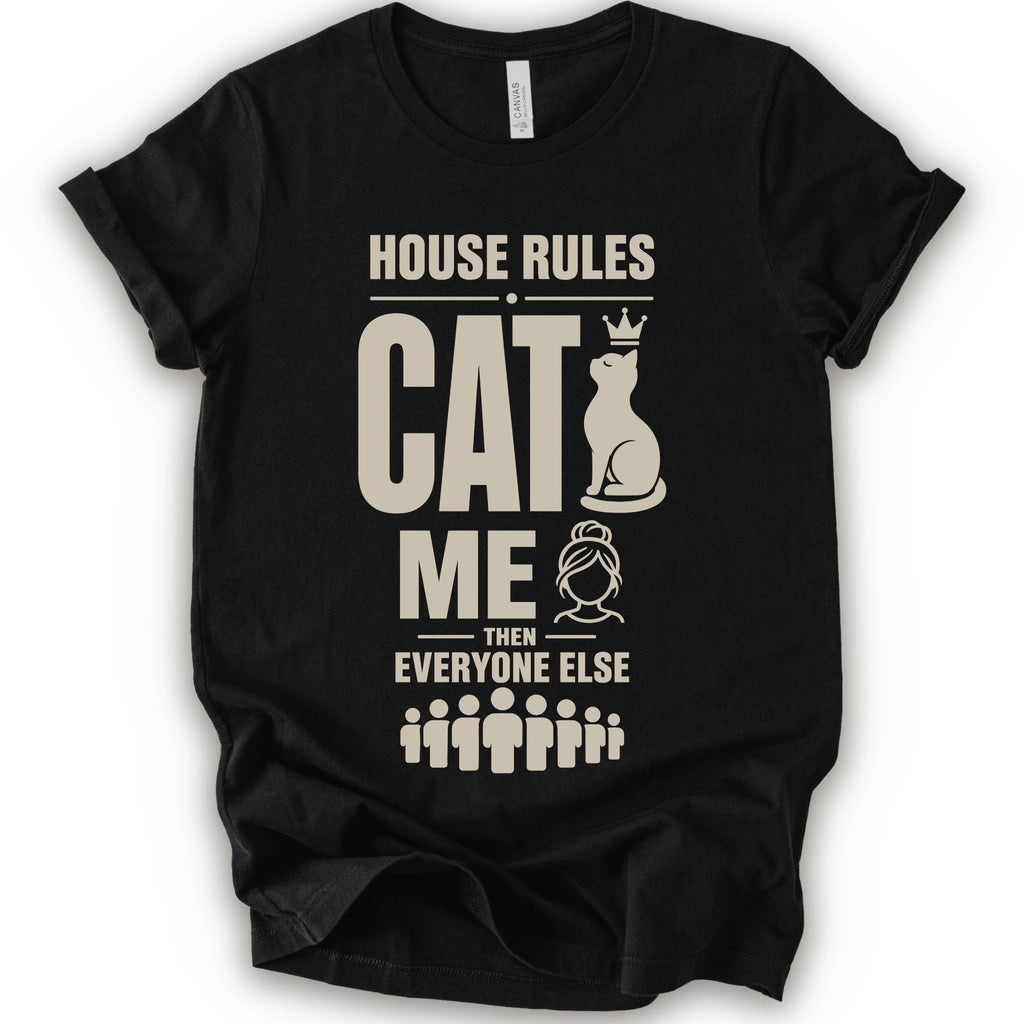 A black short-sleeve crewneck t-shirt with a beige graphic print that reads 'HOUSE RULES CAT ME THEN EVERYONE ELSE' accompanied by illustrations of a cat wearing a crown and stick-figure family members.