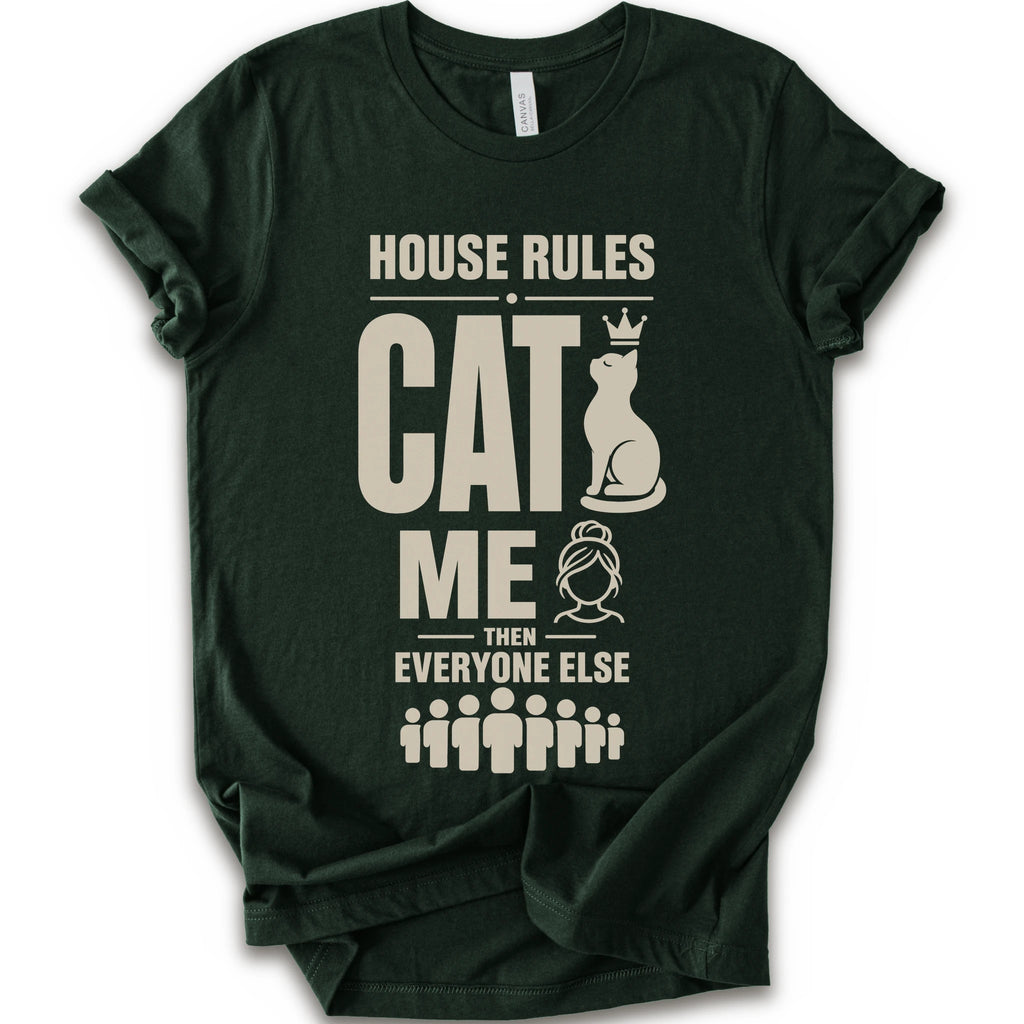 A forest short-sleeve crewneck t-shirt with a beige graphic print that reads 'HOUSE RULES CAT ME THEN EVERYONE ELSE' accompanied by illustrations of a cat wearing a crown and stick-figure family members.
