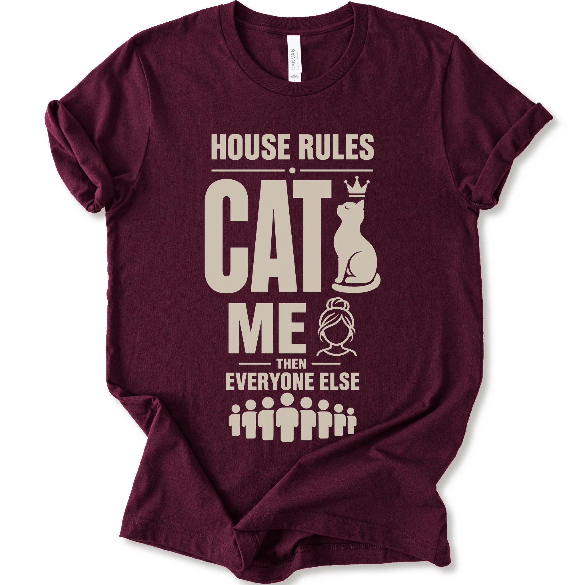 A maroon short-sleeve crewneck t-shirt with a beige graphic print that reads 'HOUSE RULES CAT ME THEN EVERYONE ELSE' accompanied by illustrations of a cat wearing a crown and stick-figure family members.