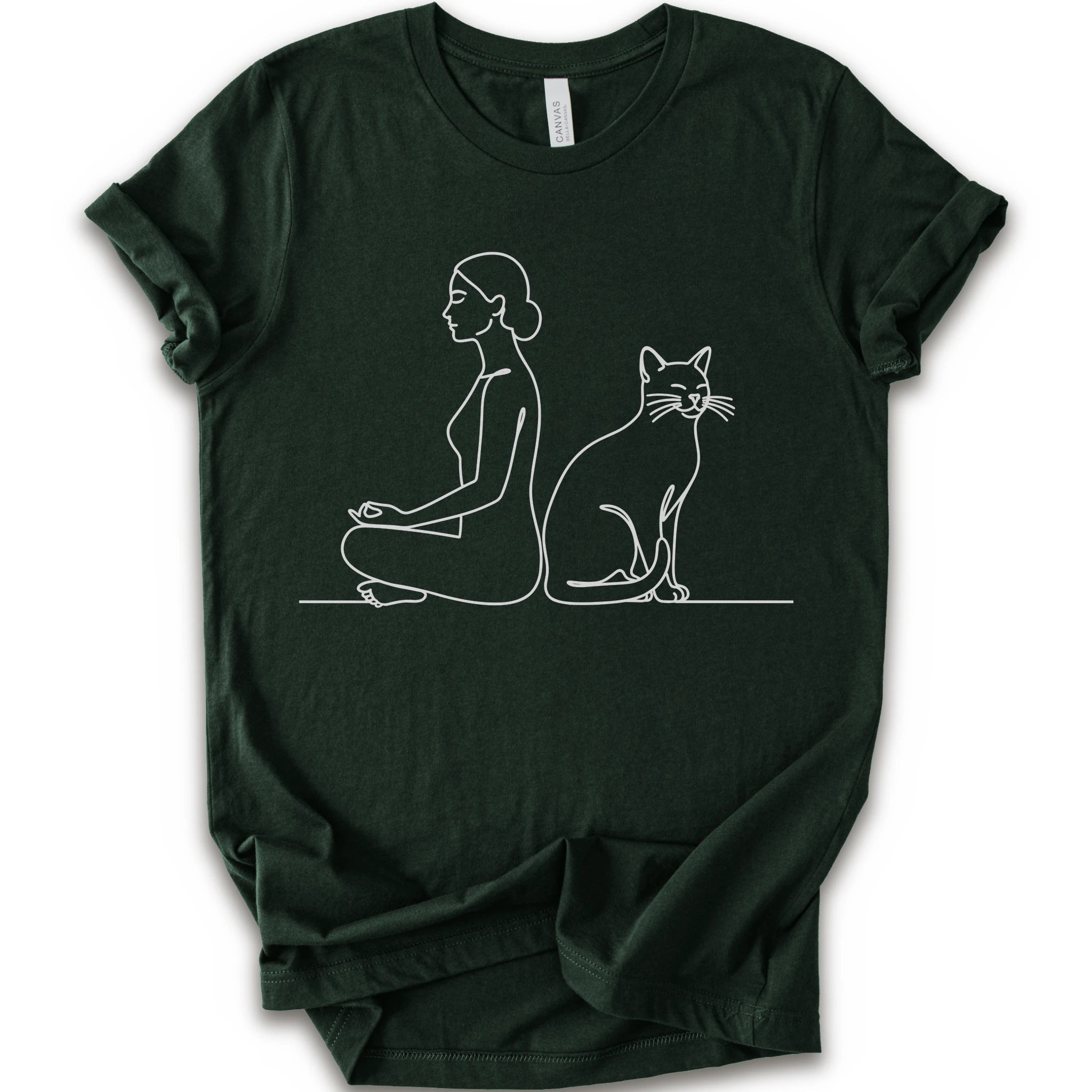 A forest short-sleeve crewneck t-shirt with a minimalist white line art graphic of a woman in a meditation pose next to a cat.