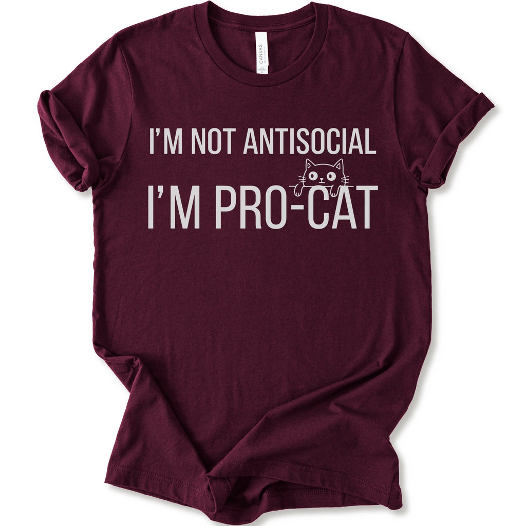 A maroon short-sleeve crewneck t-shirt with a white graphic print that reads 'I'M NOT ANTISOCIAL I'M PRO-CAT' alongside a small cartoon cat face.