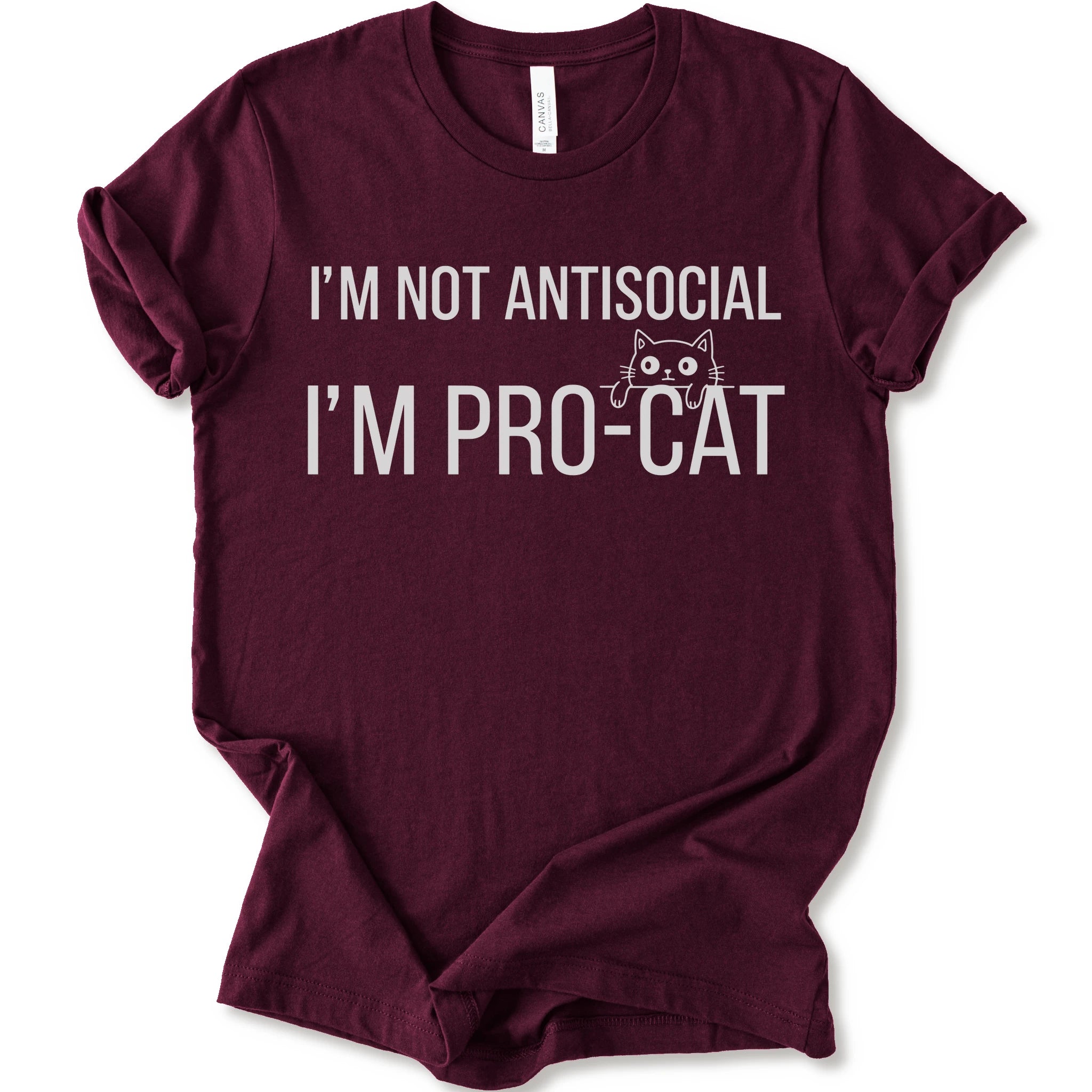 A maroon short-sleeve crewneck t-shirt with a white graphic print that reads 'I'M NOT ANTISOCIAL I'M PRO-CAT' alongside a small cartoon cat face.