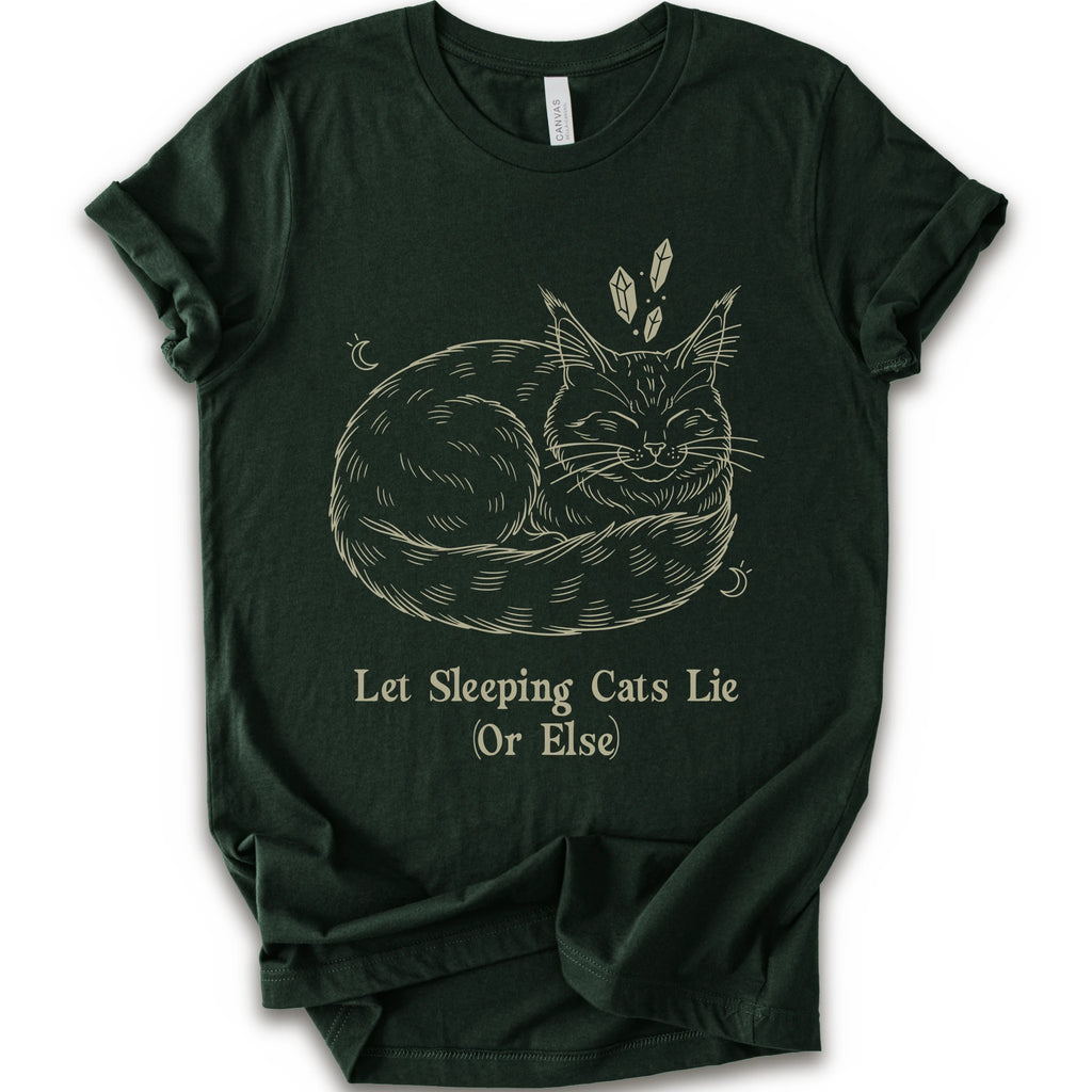 A forest short-sleeve crewneck t-shirt with a graphic of a sleeping maine coon cat in beige line art, accompanied by the text 'Let Sleeping Cats Lie (Or Else)'.