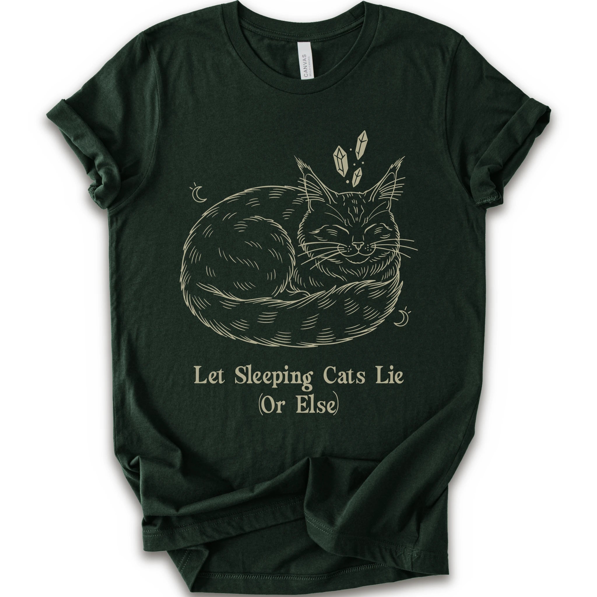 A forest short-sleeve crewneck t-shirt with a graphic of a sleeping maine coon cat in beige line art, accompanied by the text 'Let Sleeping Cats Lie (Or Else)'.