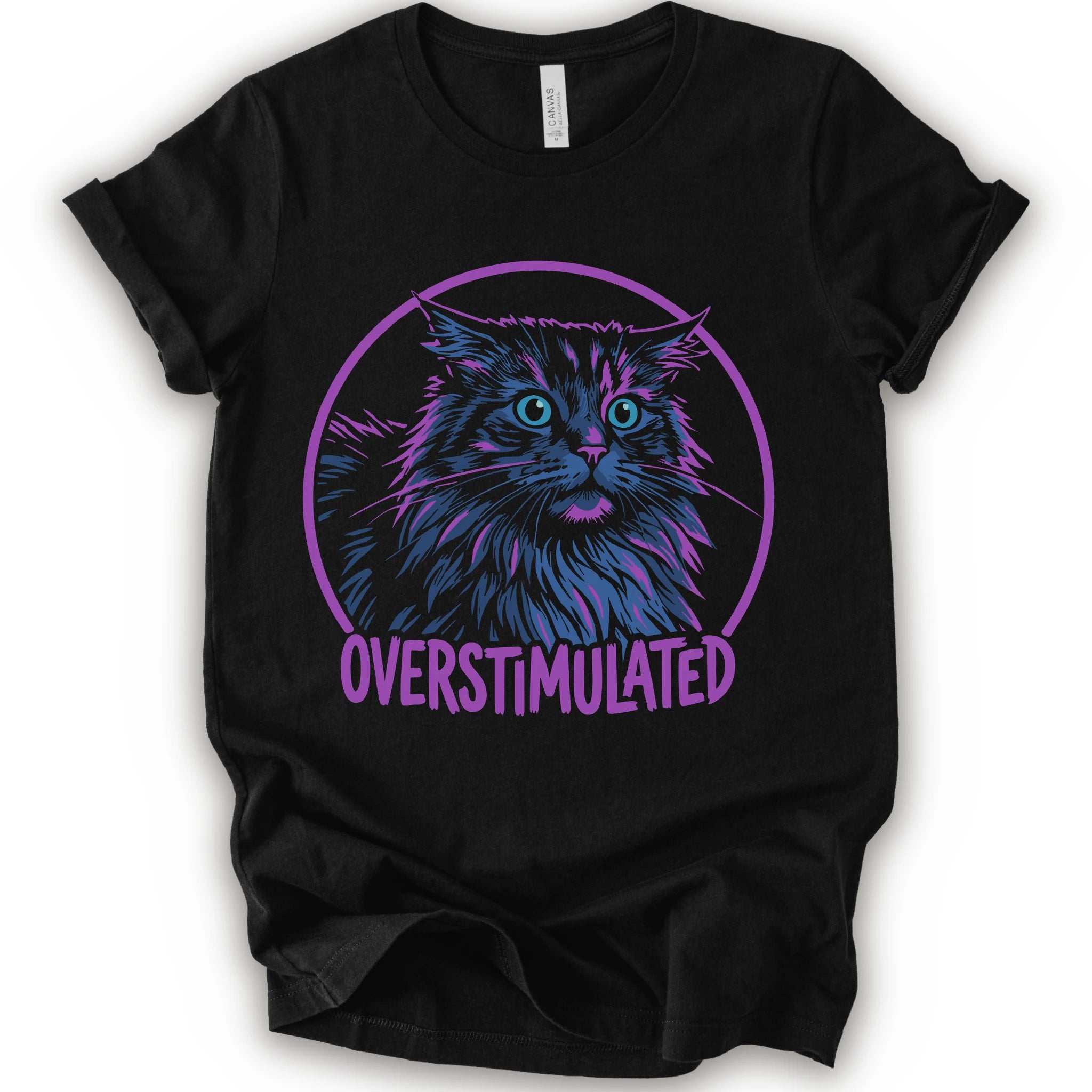 A black short-sleeve crewneck t-shirt featuring a graphic of a fluffy blue and purple maine coon cat inside a purple circle with the text 'OVERSTIMULATED' in purple below it.