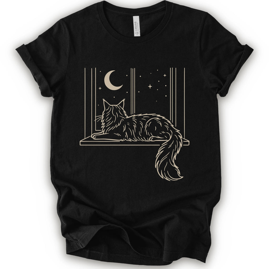 A black short-sleeve crewneck t-shirt with a graphic print of a long-haired maine coon resting on a windowsill under a crescent moon and stars.