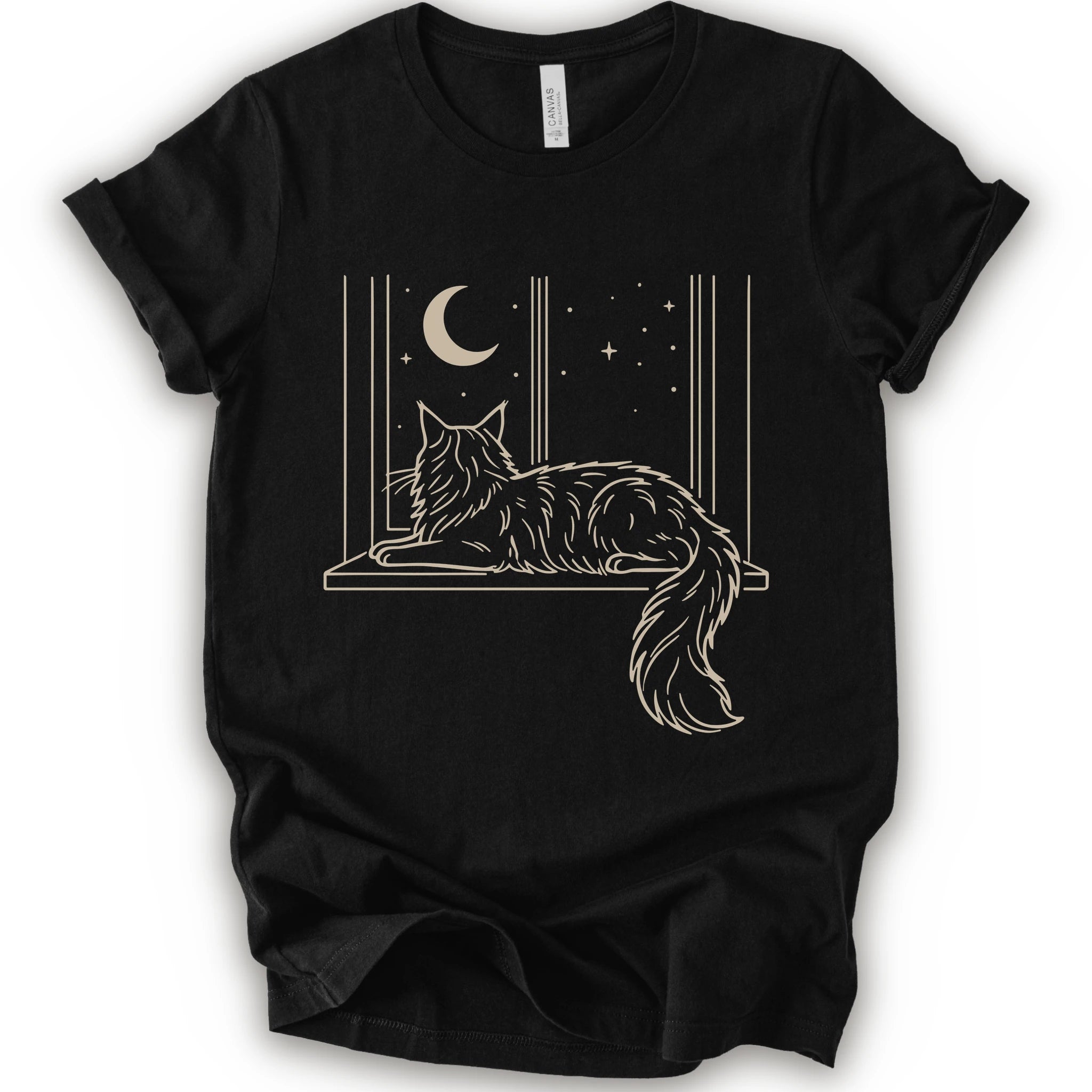 A black short-sleeve crewneck t-shirt with a graphic print of a long-haired maine coon resting on a windowsill under a crescent moon and stars.