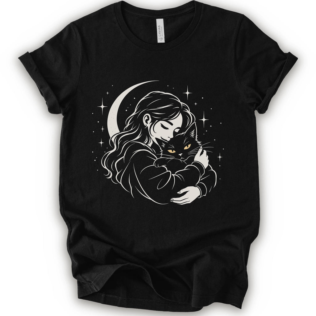 Black graphic t-shirt with a woman hugging a fluffy cat beneath a crescent moon and stars, drawn in cream lines with golden cat eyes