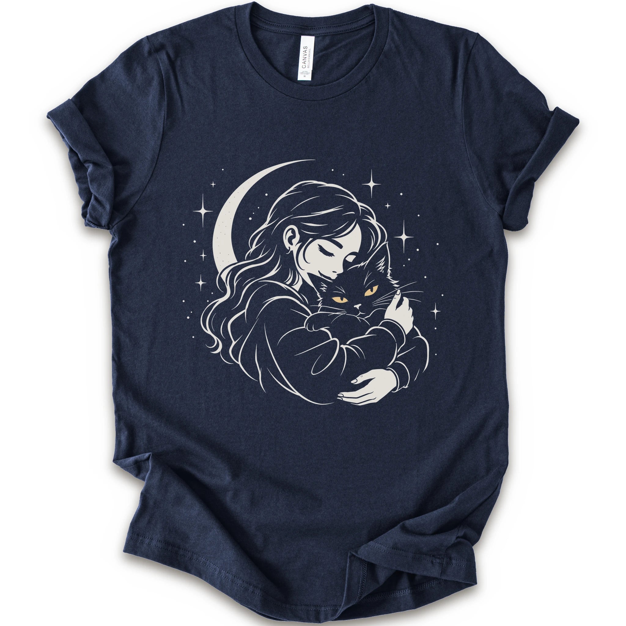 Navy graphic t-shirt with a woman hugging a fluffy cat beneath a crescent moon and stars, drawn in cream lines with golden cat eyes
