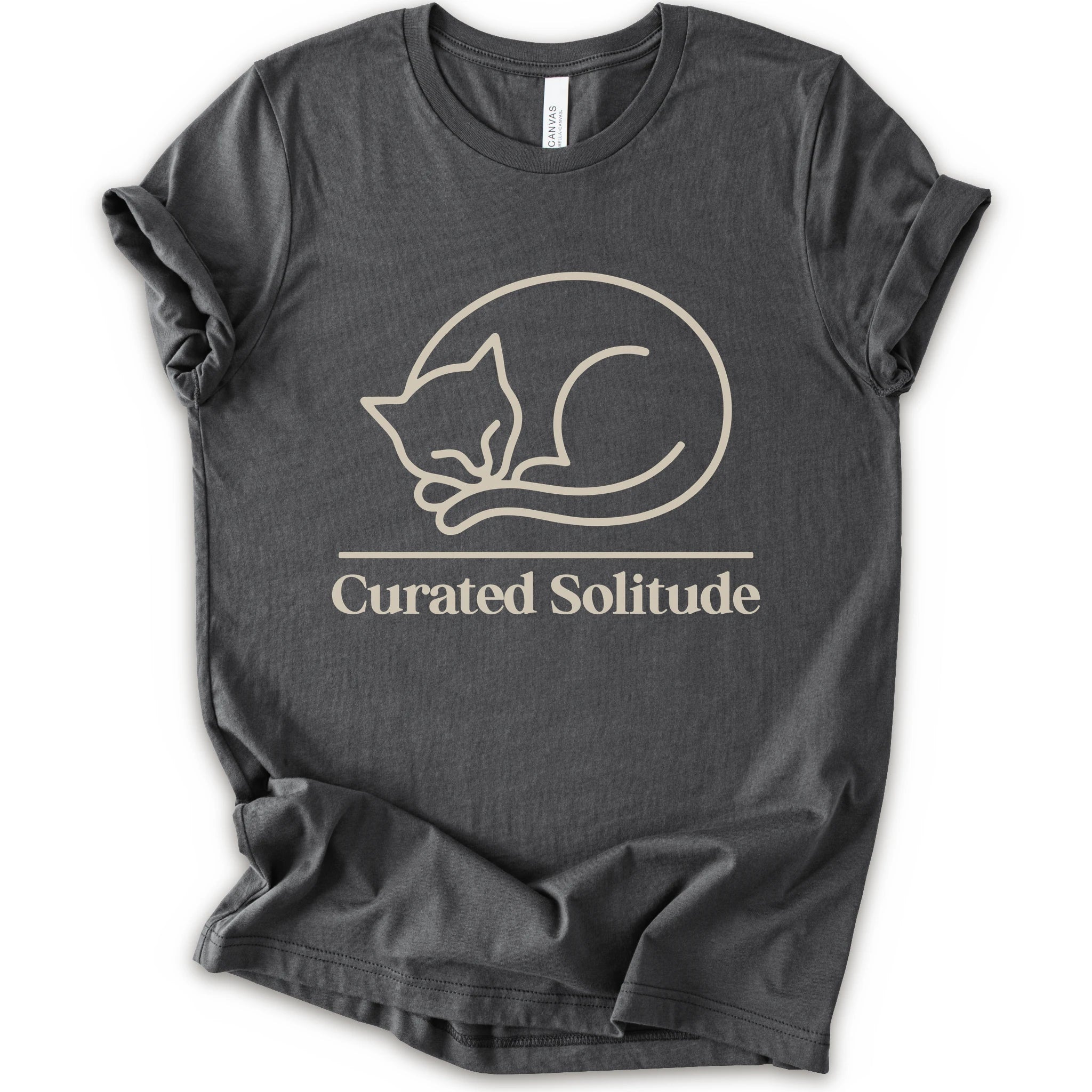 A asphalt short-sleeve crewneck t-shirt with a cream-colored graphic of a curled-up sleeping cat, with the text 'Curated Solitude' printed below.