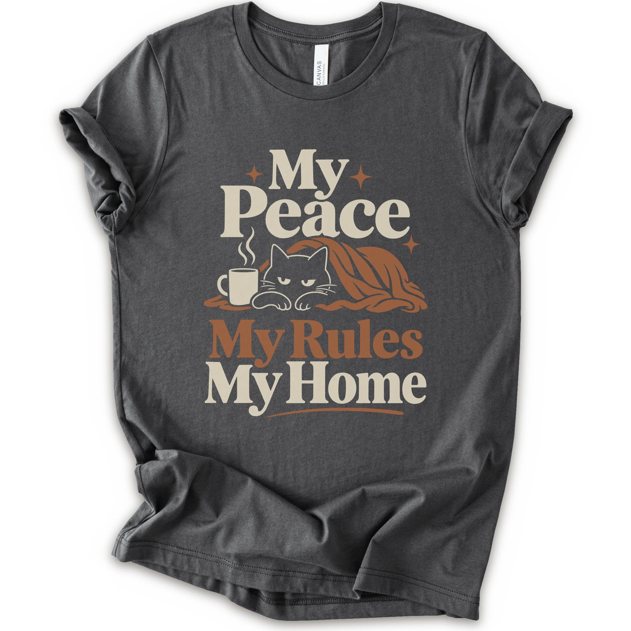 A asphalt short-sleeve crewneck t-shirt with a retro-style graphic print that reads 'My Peace My Rules My Home' in cream and brown text, featuring an illustration of a black cat under a brown blanket next to a small mug.