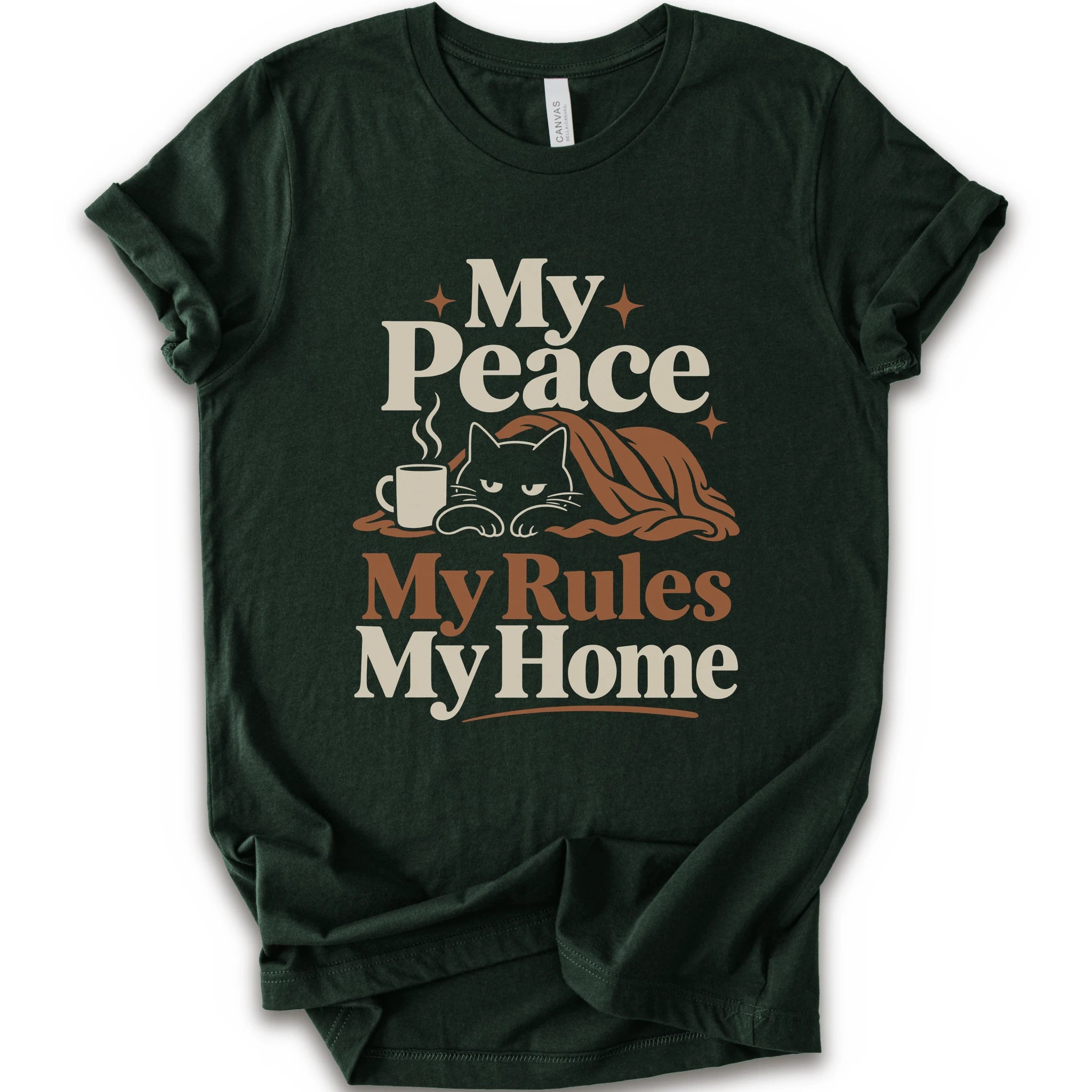 A forest short-sleeve crewneck t-shirt with a retro-style graphic print that reads 'My Peace My Rules My Home' in cream and brown text, featuring an illustration of a black cat under a brown blanket next to a small mug.