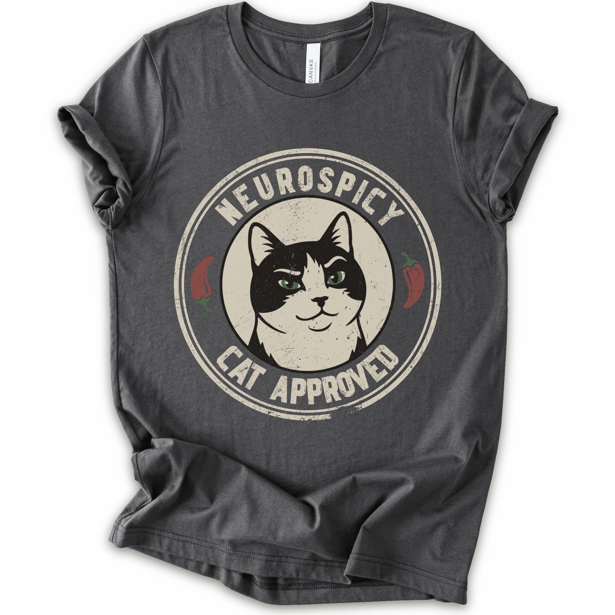 A asphalt short-sleeve crewneck t-shirt with a distressed circular graphic on the chest featuring a black and white cat with green eyes, red peppers, and the text 'NEUROSPICY, CAT APPROVED'.