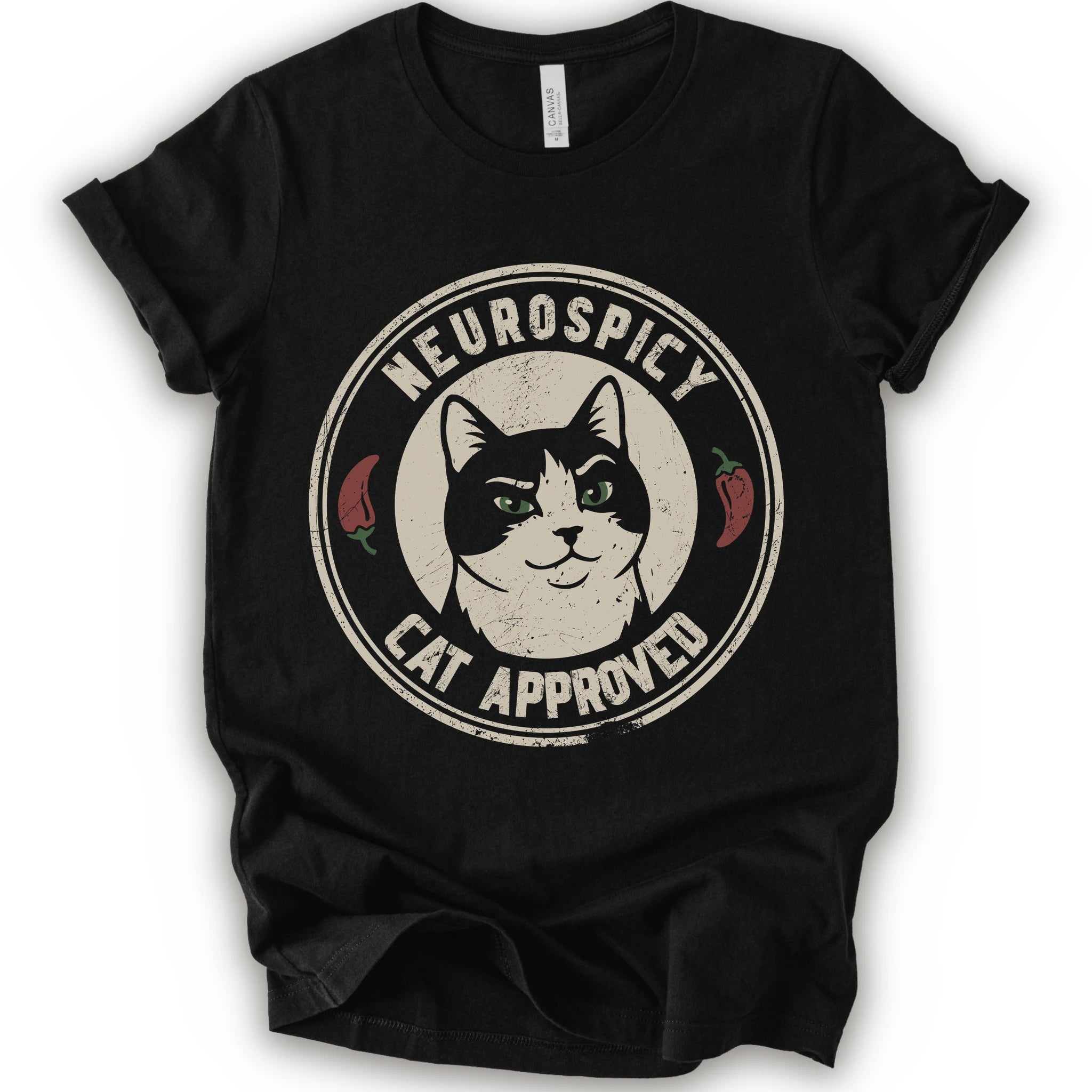 A black short-sleeve crewneck t-shirt with a distressed circular graphic on the chest featuring a black and white cat with green eyes, red peppers, and the text 'NEUROSPICY, CAT APPROVED'.
