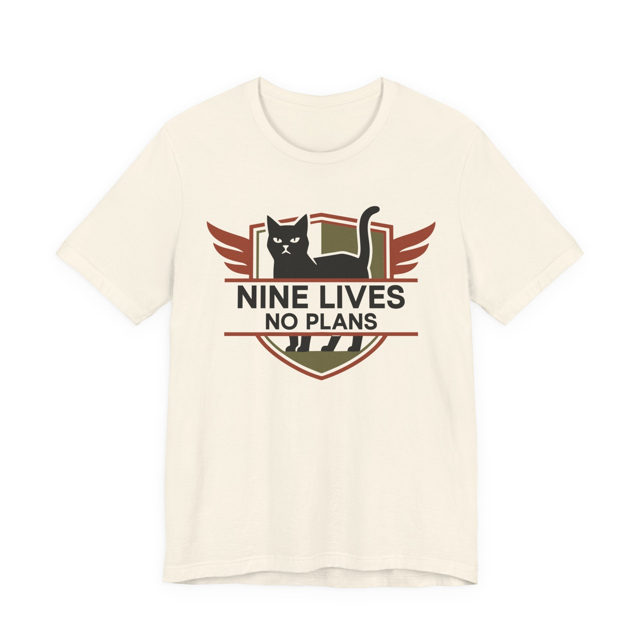 An off-white short-sleeve t-shirt with a graphic on the chest featuring black cat in a rust and olive retro badge with the text “NINE LIVES NO PLANS”