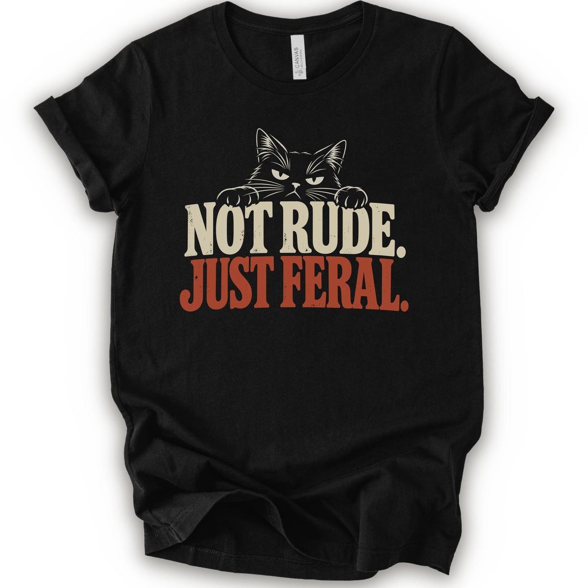 A black short-sleeve t-shirt with a graphic print of a cat with narrowed eyes and visible paws peers over the words “NOT RUDE.” above a large rust-colored “JUST FERAL.” The design uses bold distressed serif lettering in cream and rust with a retro graphic look.