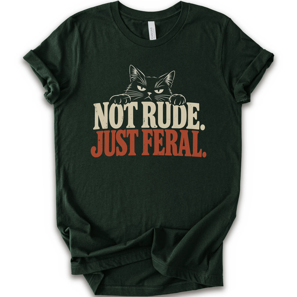 A forest short-sleeve t-shirt with a graphic print of a cat with narrowed eyes and visible paws peers over the words “NOT RUDE.” above a large rust-colored “JUST FERAL.” The design uses bold distressed serif lettering in cream and rust with a retro graphic look.
