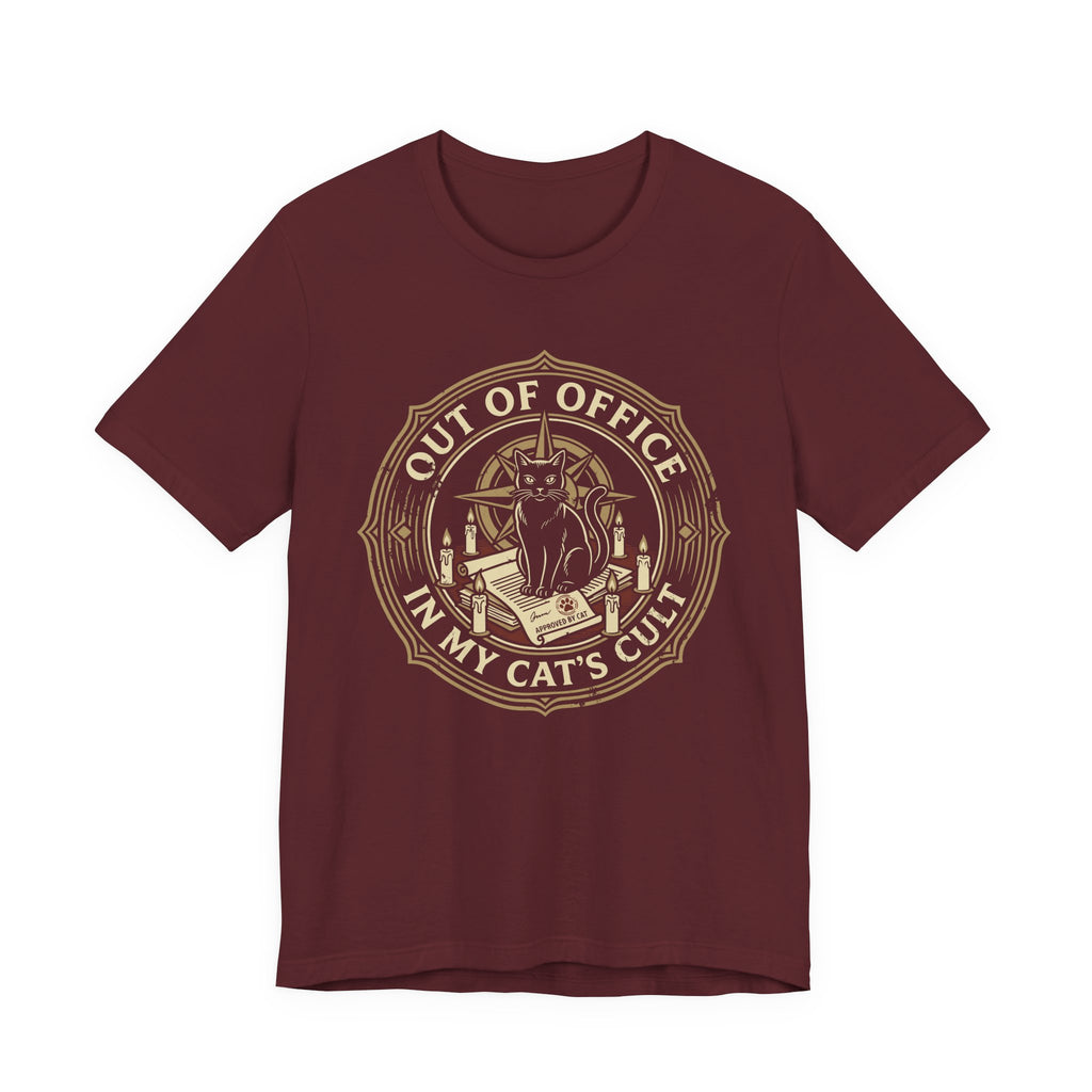 Red Tee with Black cat surrounded by candles and books in a vintage badge reading “Out of Office in My Cat’s Cult”