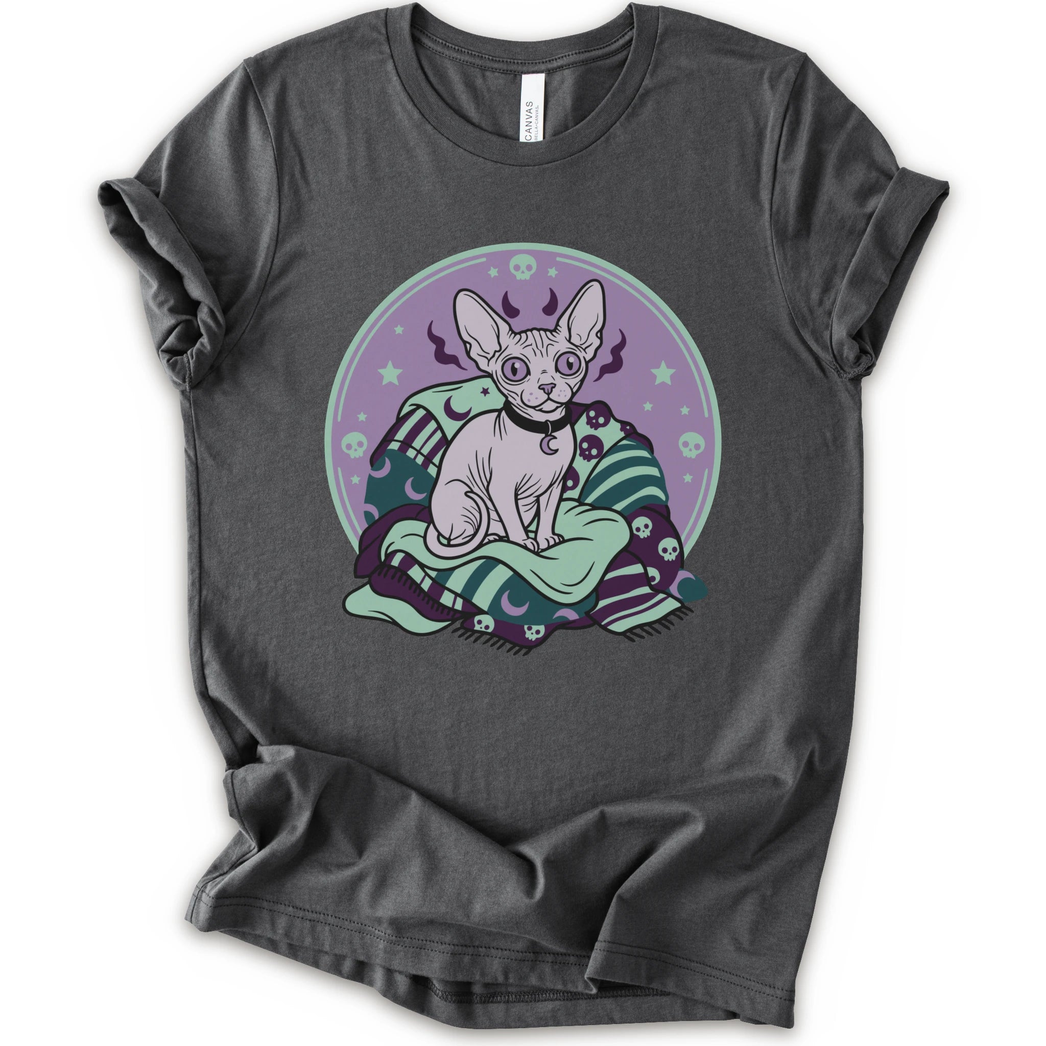 A asphalt short-sleeve crewneck t-shirt featuring a graphic print of a hairless cat sitting on a green and purple patterned blanket inside a purple circular frame.