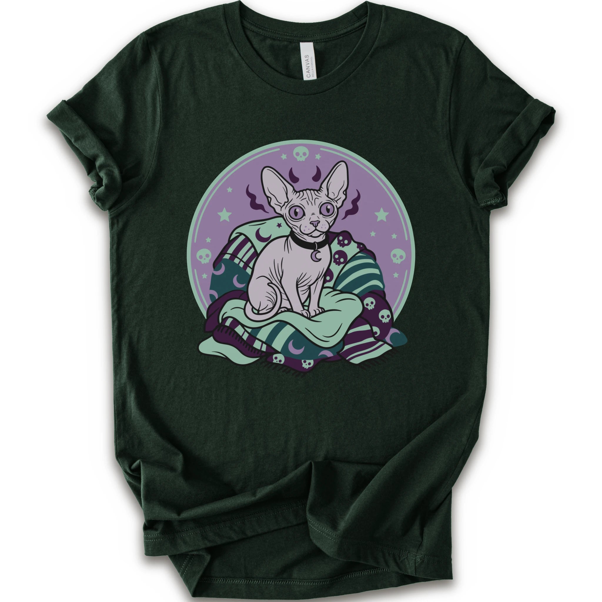 A forest short-sleeve crewneck t-shirt featuring a graphic print of a hairless cat sitting on a green and purple patterned blanket inside a purple circular frame.