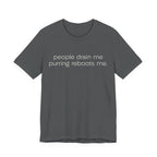 A asphalt short-sleeve crewneck t-shirt featuring a graphic with 
minimalist lowercase text reading “people drain me. purring reboots me.” for an introvert cat T-shirt