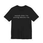 A black short-sleeve crewneck t-shirt featuring a graphic with 
minimalist lowercase text reading “people drain me. purring reboots me.” for an introvert cat T-shirt