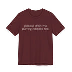 A maroon short-sleeve crewneck t-shirt featuring a graphic with 
minimalist lowercase text reading “people drain me. purring reboots me.” for an introvert cat T-shirt