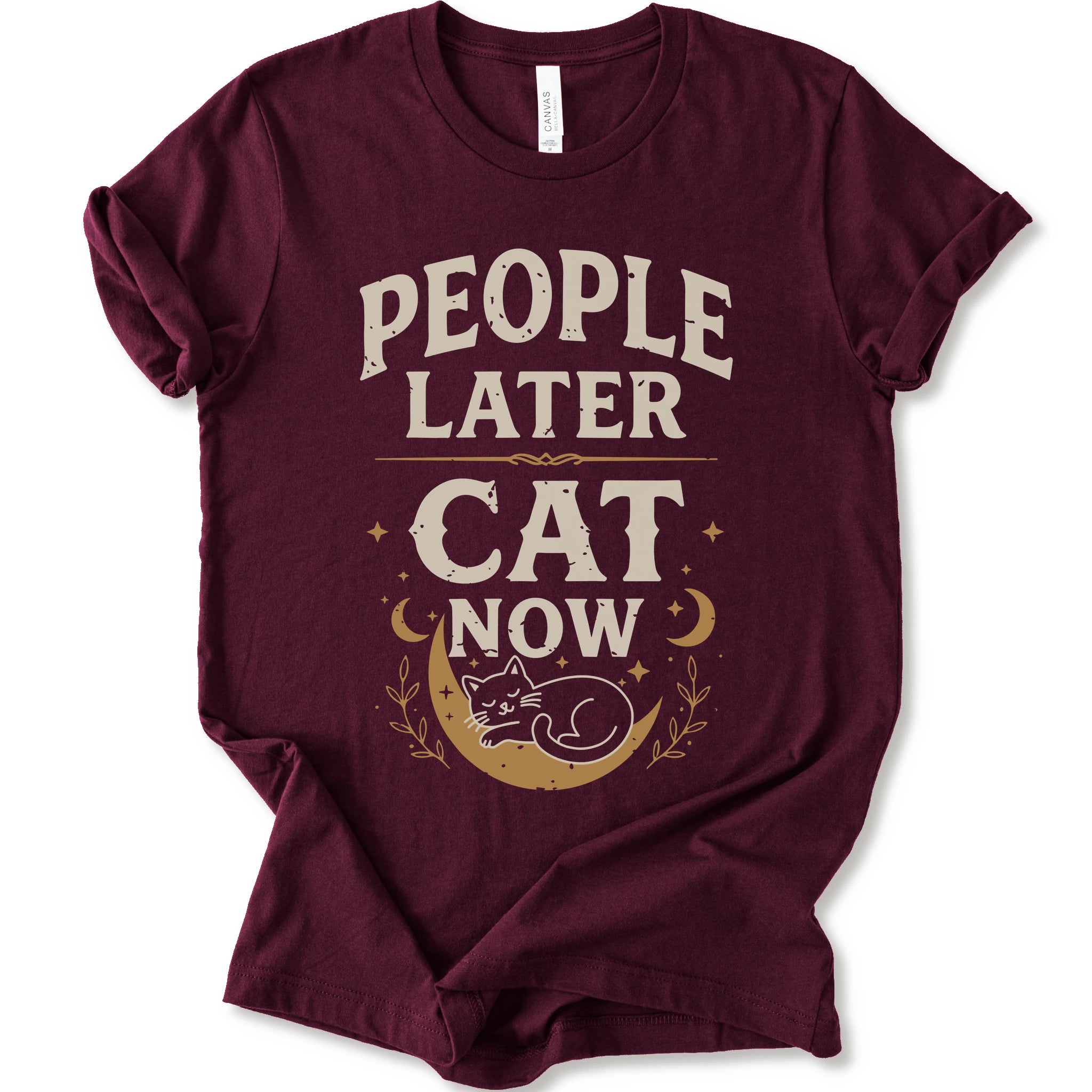 A maroon short-sleeve crewneck t-shirt with a distressed graphic print that reads 'PEOPLE LATER CAT NOW' in cream and tan lettering, featuring a sleeping cat on a crescent moon with stars and leaves.