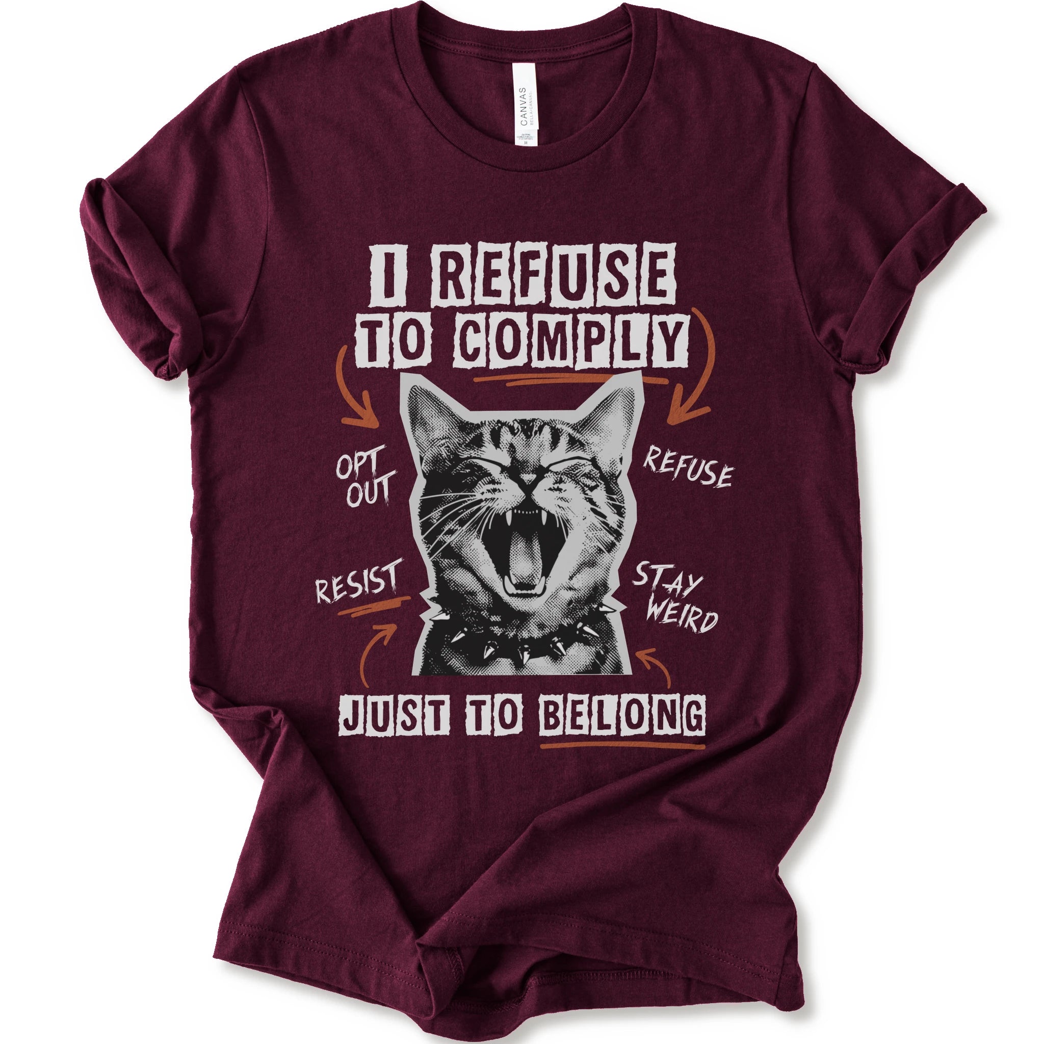A maroon short-sleeve graphic t-shirt featuring a screaming cat illustration and the text 'I REFUSE TO COMPLY' and 'JUST TO BELONG' in white and orange.