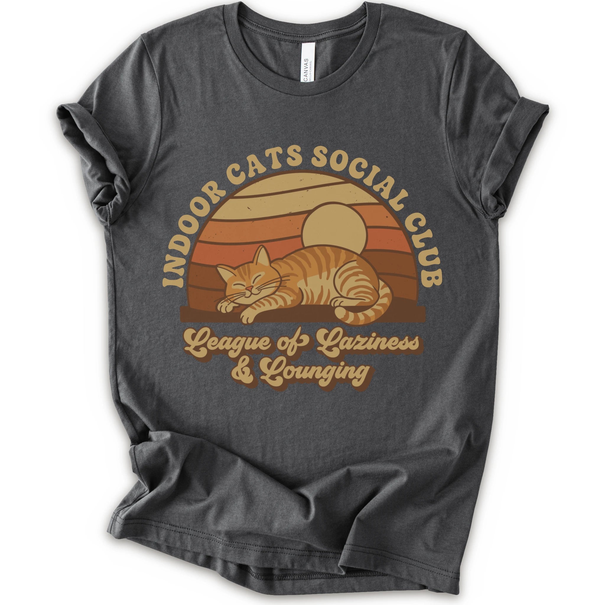 A asphalt short-sleeve crewneck t-shirt with a retro-style graphic of an orange tabby cat sleeping under a sunset, with the text 'INDOOR CATS SOCIAL CLUB' and 'League of Laziness & Younging'.
