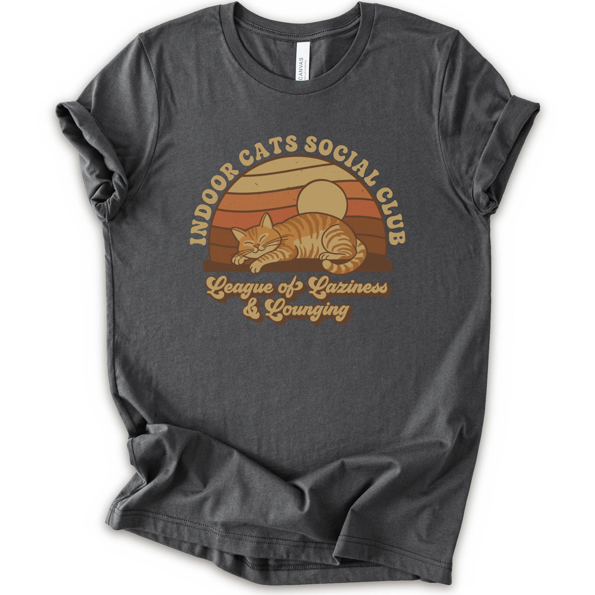 An ashalt short-sleeve crewneck t-shirt featuring a retro-style graphic of an orange tabby cat sleeping under a sunset, with the text 'INDOOR CATS SOCIAL CLUB' and 'League of Laziness & Lounging'.