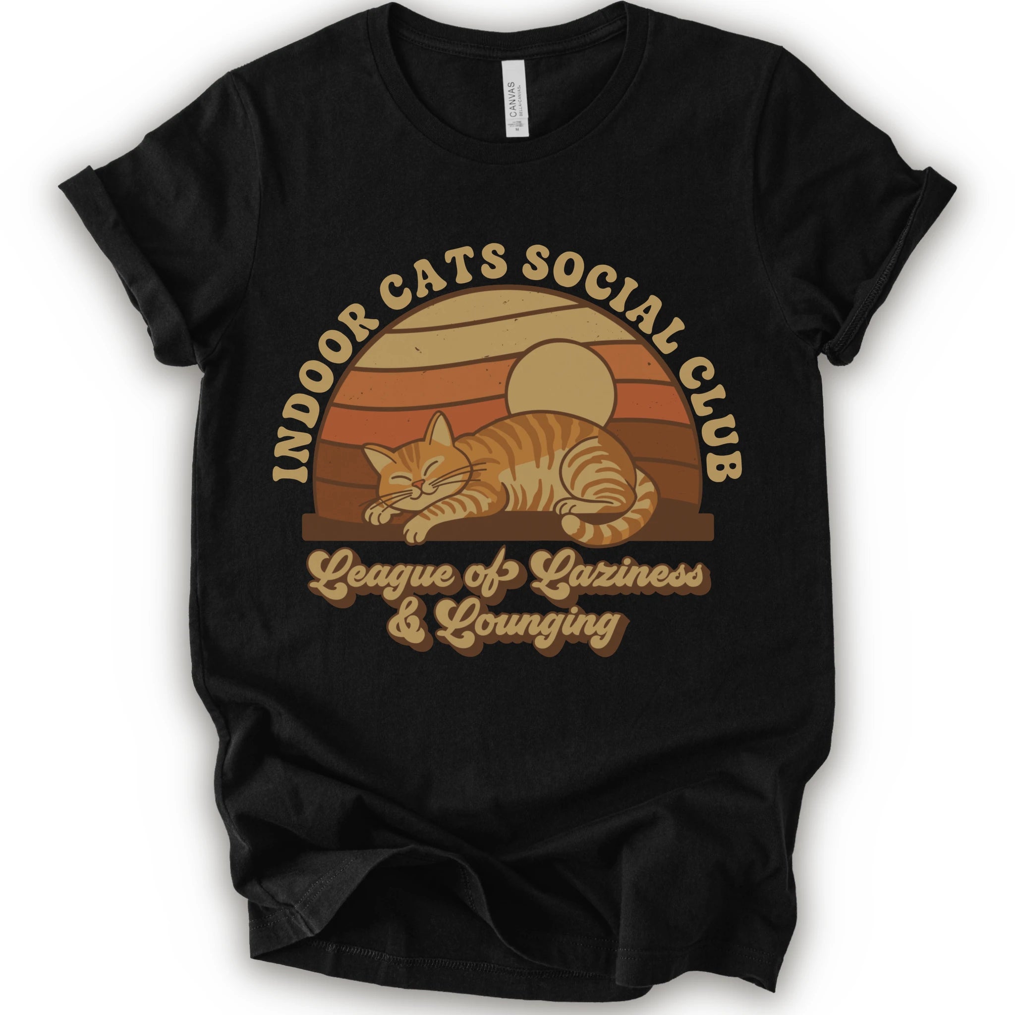 A black short-sleeve crewneck t-shirt with a retro-style graphic of an orange tabby cat sleeping under a sunset, with the text 'INDOOR CATS SOCIAL CLUB' and 'League of Laziness & Younging'.