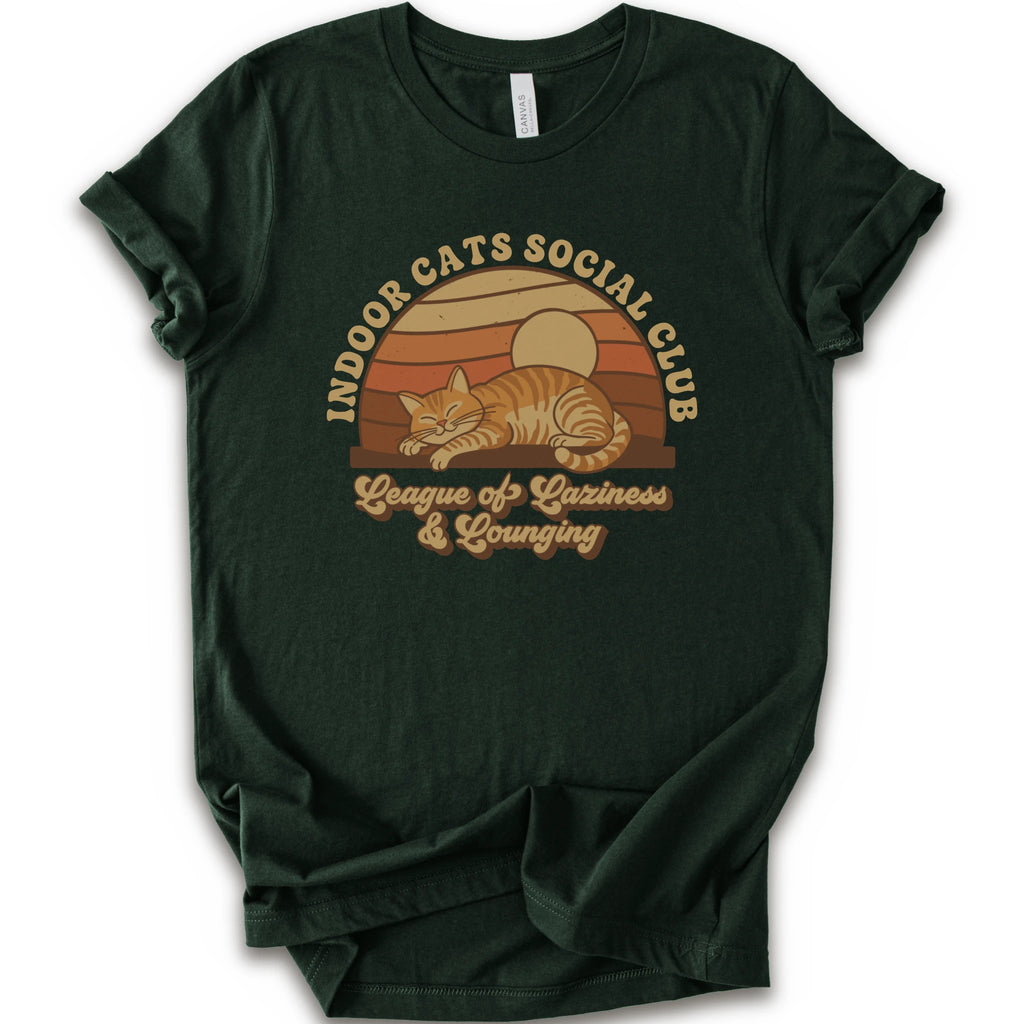 A forest short-sleeve crewneck t-shirt featuring a retro-style graphic of an orange tabby cat sleeping under a sunset, with the text 'INDOOR CATS SOCIAL CLUB' and 'League of Laziness & Lounging'.