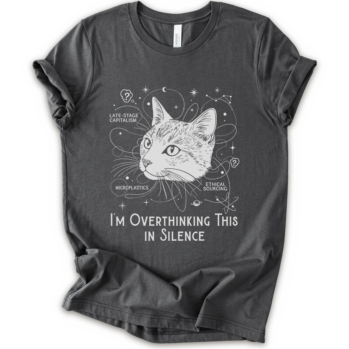 An asphalt short-sleeve crewneck t-shirt with a white graphic print of a cat's head surrounded by celestial and philosophical doodles, with the text 'I'M OVERTHINKING THIS IN SILENCE'.
