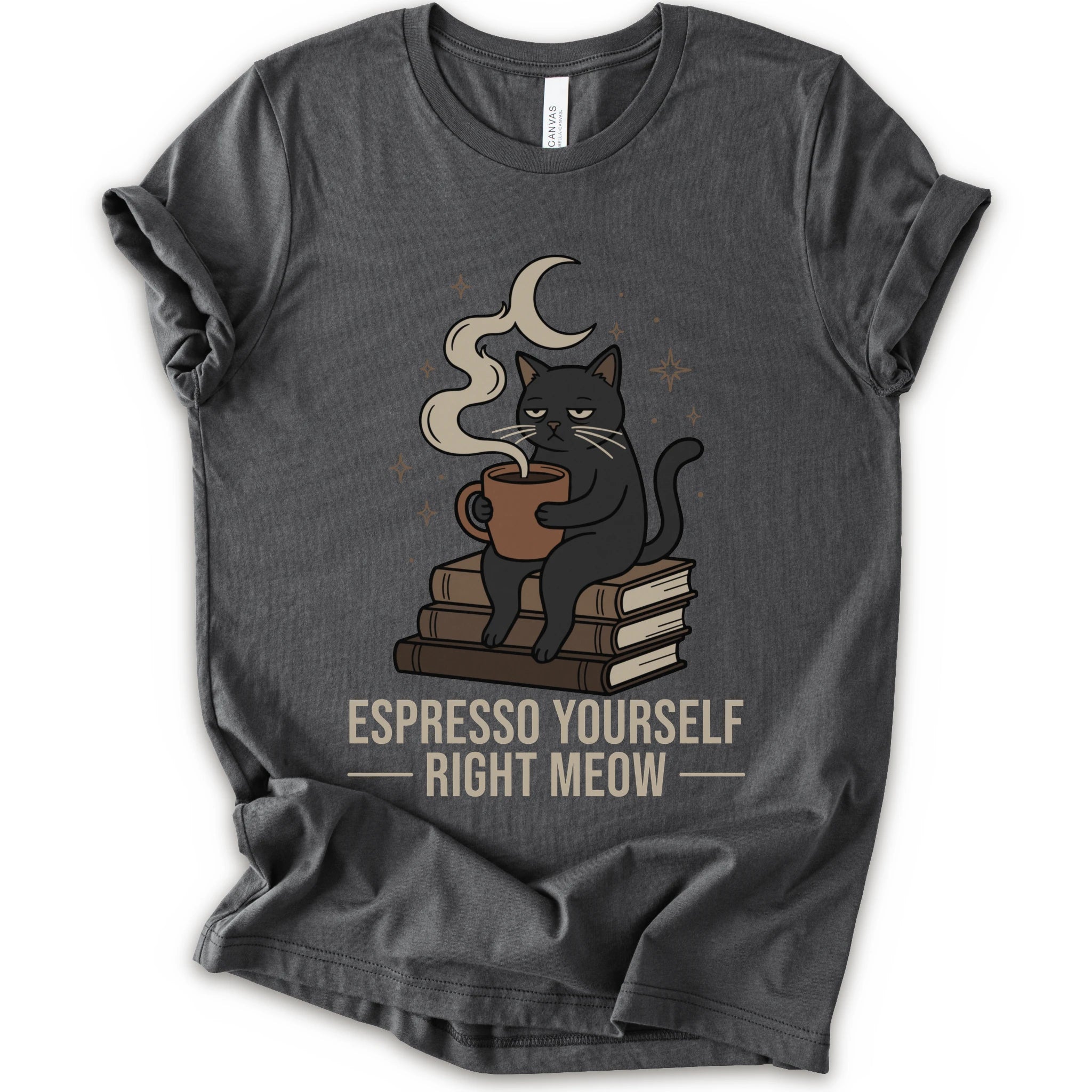 A asphalt short-sleeve crewneck t-shirt featuring a graphic of a black cat sitting on books and holding an espresso cup, with a crescent moon and stars above. The text 'ESPRESSO YOURSELF RIGHT MEOW' is printed below in beige.