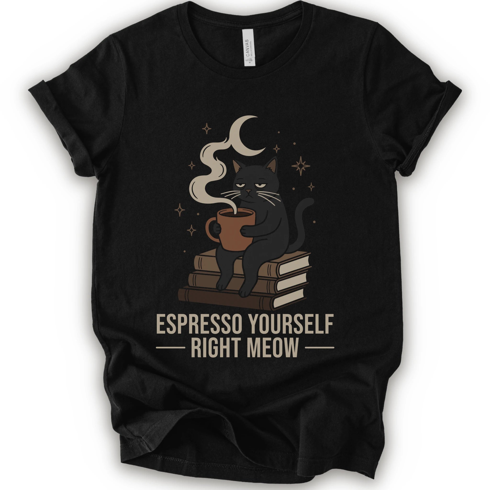 A black short-sleeve crewneck t-shirt featuring a graphic of a black cat sitting on books and holding an espresso cup, with a crescent moon and stars above. The text 'ESPRESSO YOURSELF RIGHT MEOW' is printed below in beige.