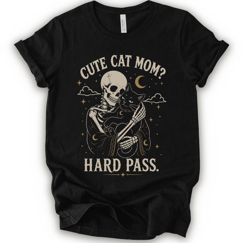 A black short-sleeve crewneck t-shirt with a vintage-style graphic of a skeleton cat holding a black cat under the text 'CUTE CAT MOM? HARD PASS.' in a distressed cream color.