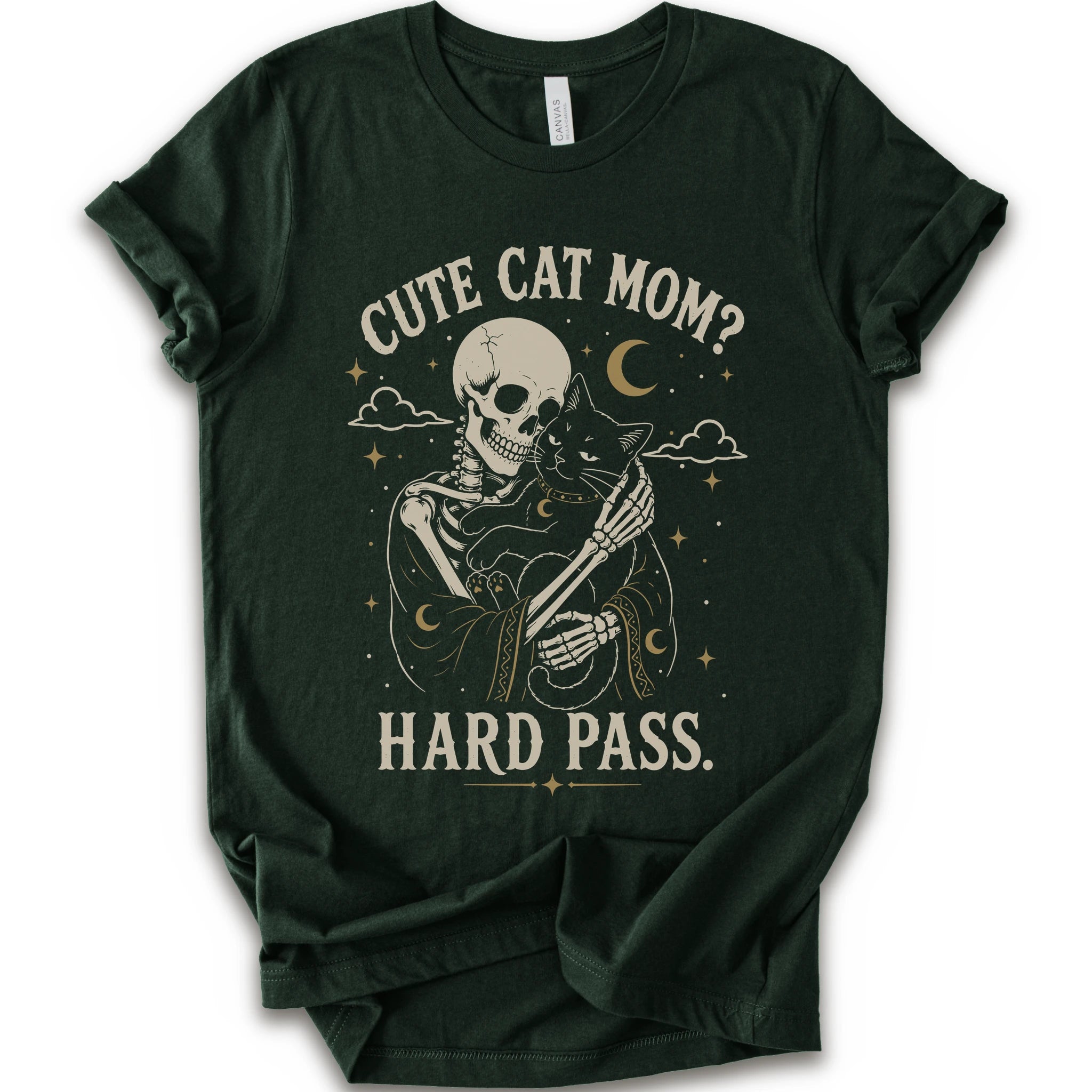 A forest short-sleeve crewneck t-shirt with a vintage-style graphic of a skeleton cat holding a black cat under the text 'CUTE CAT MOM? HARD PASS.' in a distressed cream color.