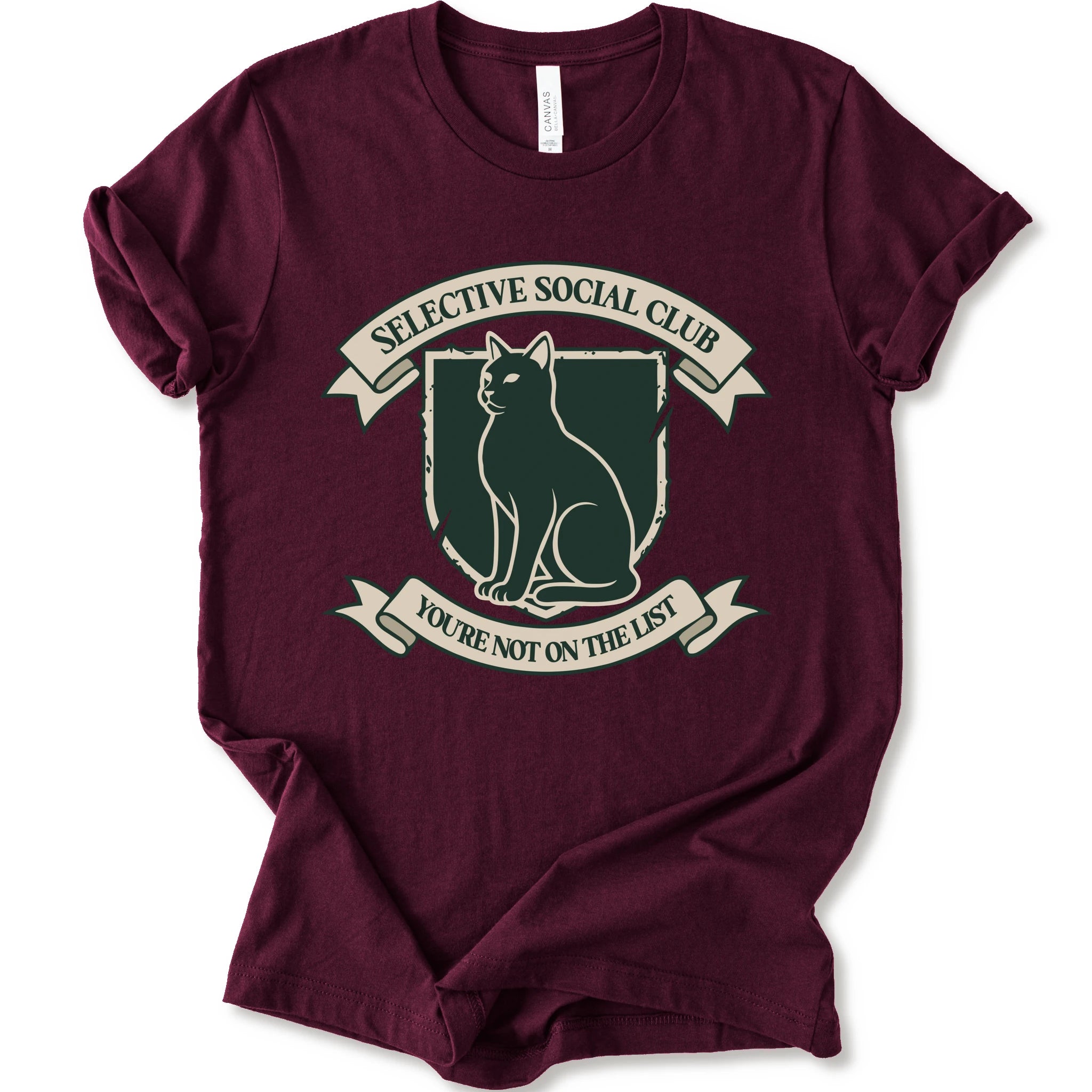 A maroon short-sleeve crewneck t-shirt with a distressed graphic of a cat inside a crest, surrounded by banners reading 'SELECTIVE SOCIAL CLUB' and 'YOU'RE NOT ON THE LIST'.