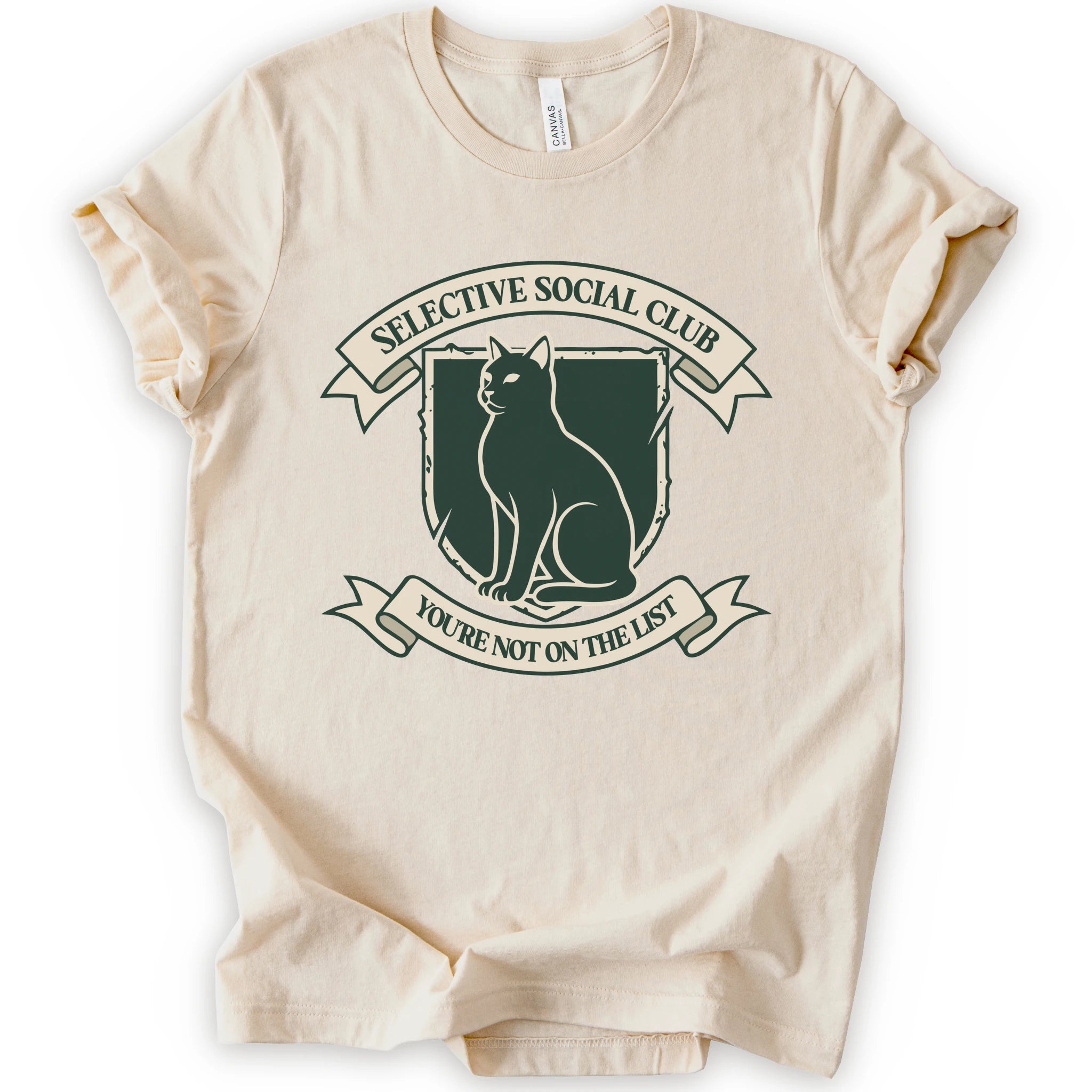 A natural short-sleeve crewneck t-shirt with a distressed graphic of a cat inside a crest, surrounded by banners reading 'SELECTIVE SOCIAL CLUB' and 'YOU'RE NOT ON THE LIST'.