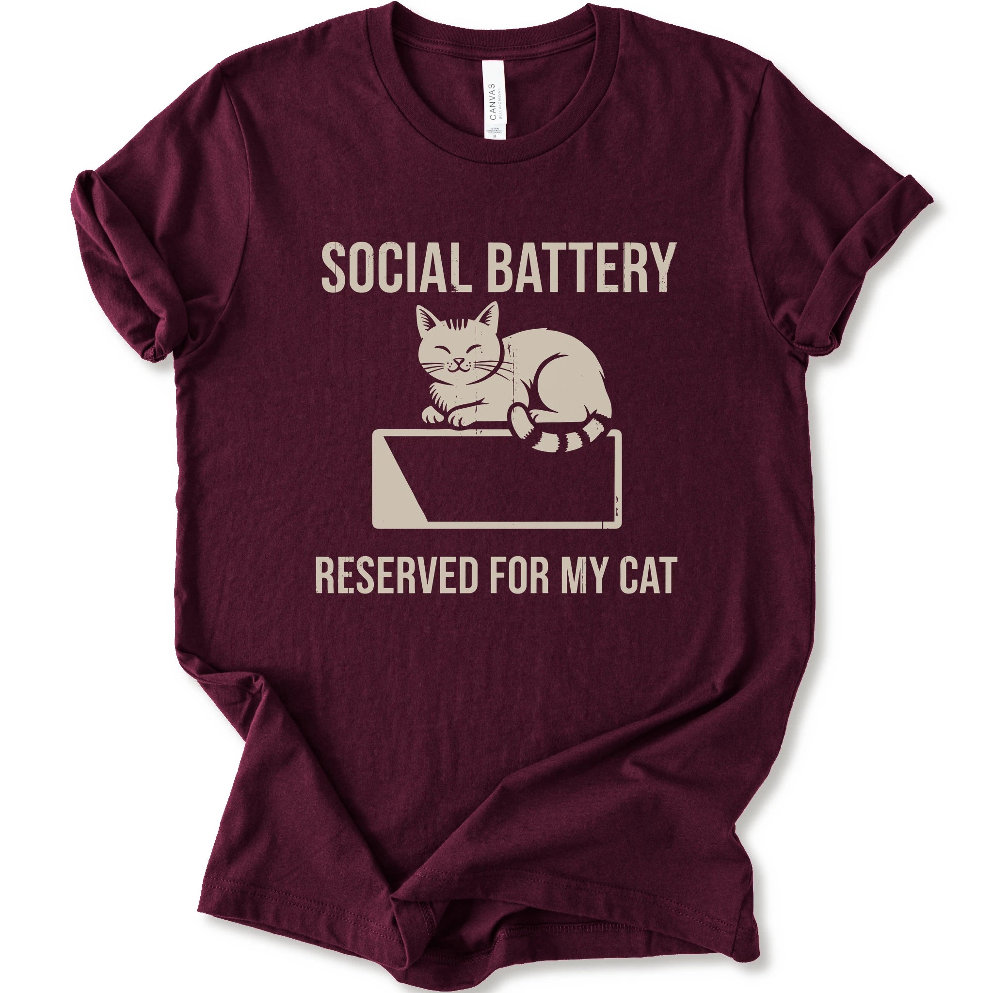 A maroon short-sleeve crewneck T-shirt with a cat on a low battery graphic and “Social Battery Reserved for My Cat” text.