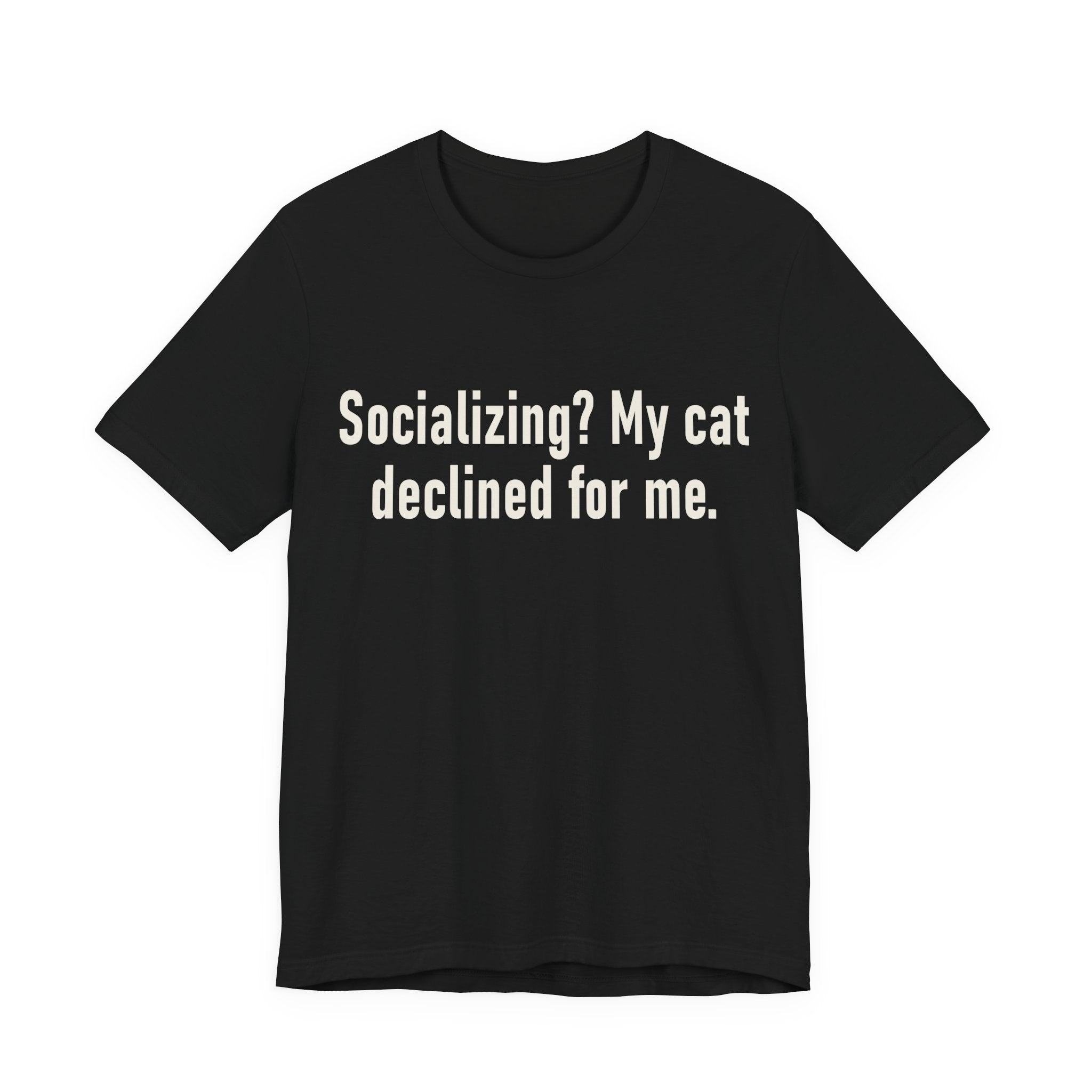 A black short-sleeve crewneck t-shirt featuring a graphic with large cream-colored text reads “Socializing? My cat declined for me.” across two centered lines. The design is minimal, high-contrast and entirely typographic.