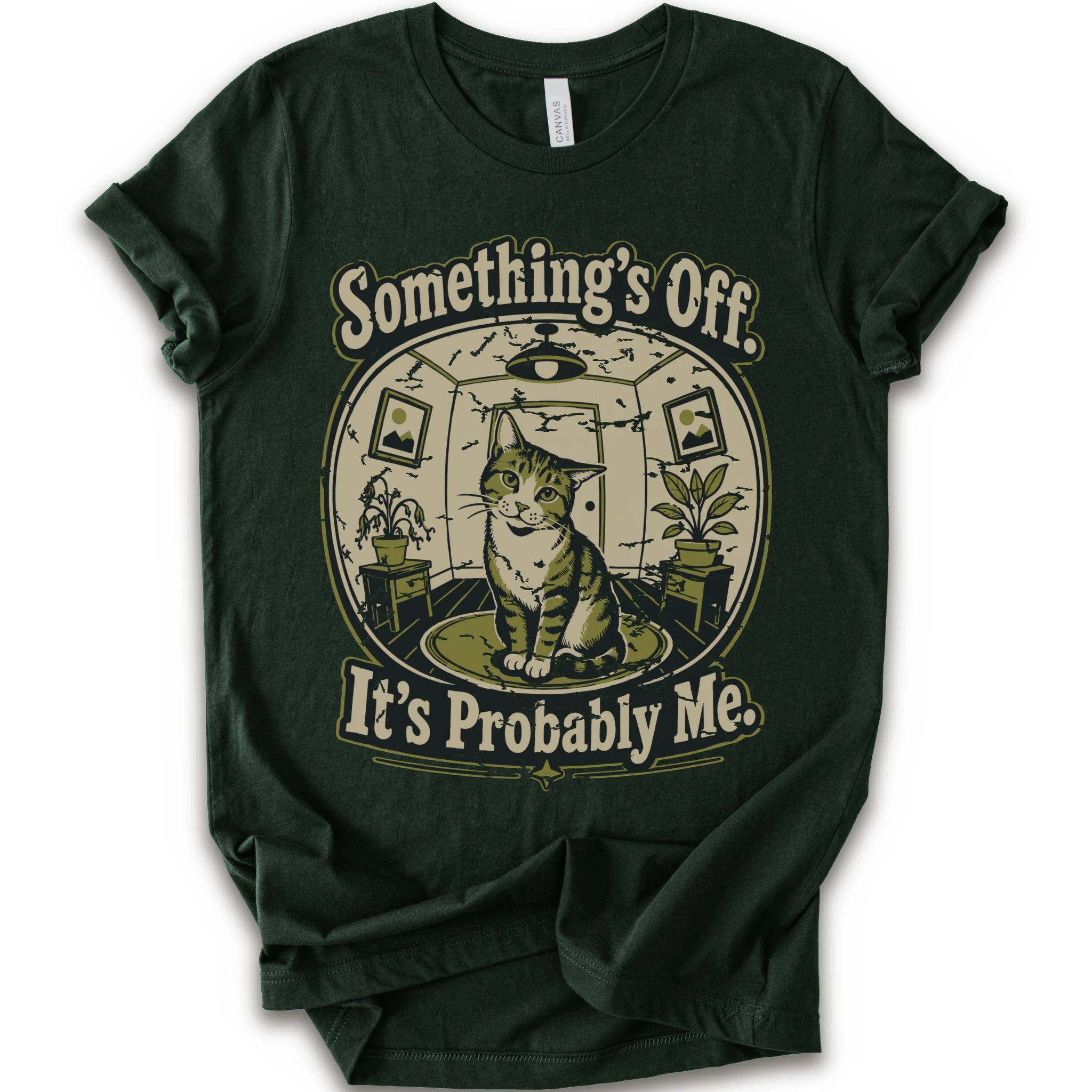 A forest short-sleeve crewneck t-shirt with a vintage-style graphic of a cat in a hat inside a circular room, with the text 'Something's Off. It's Probably Me.