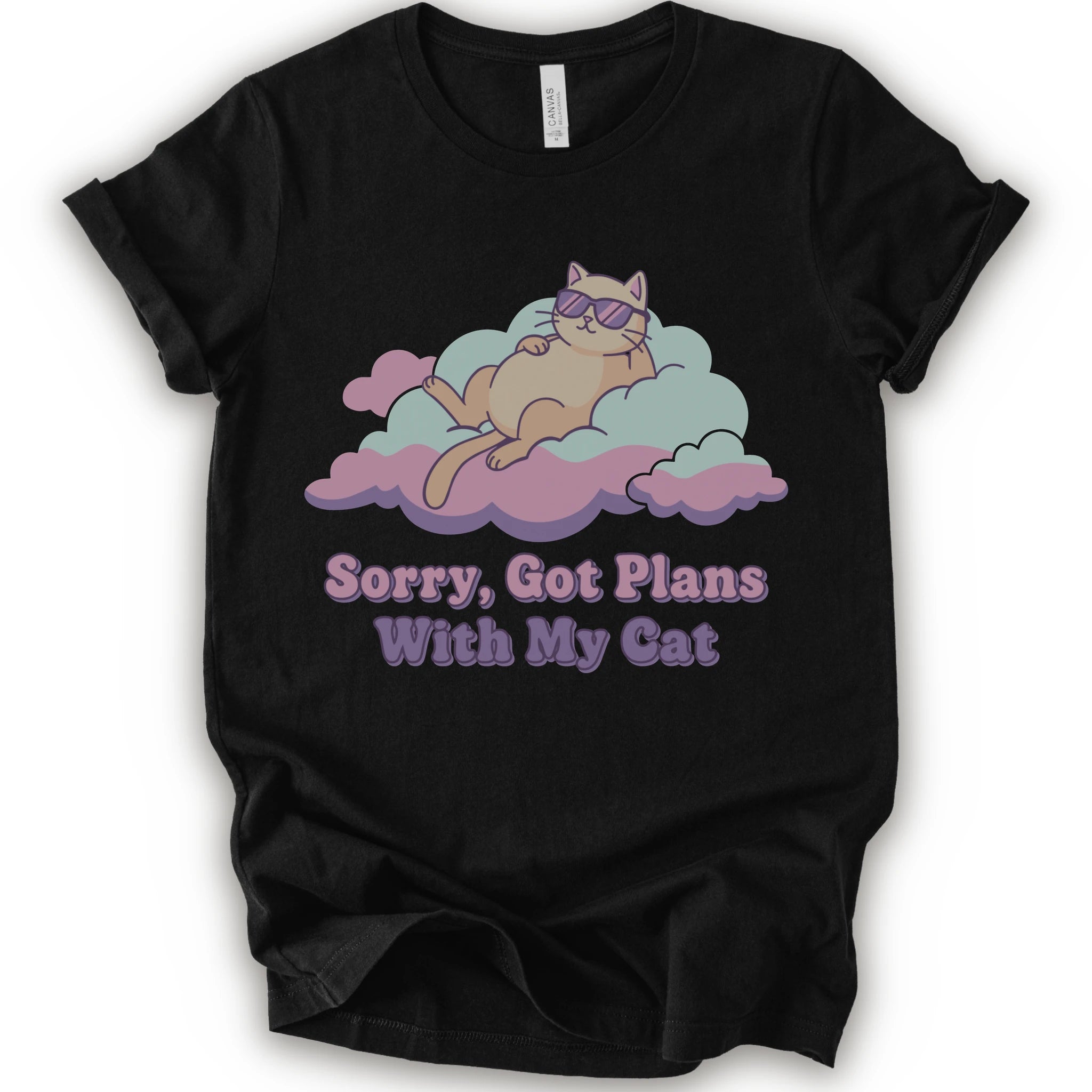 A black short-sleeve t-shirt with a graphic of a sleeping orange cat wearing sunglasses on pink and light blue clouds, with the text 'Sorry, Got Plans With My Cat'.