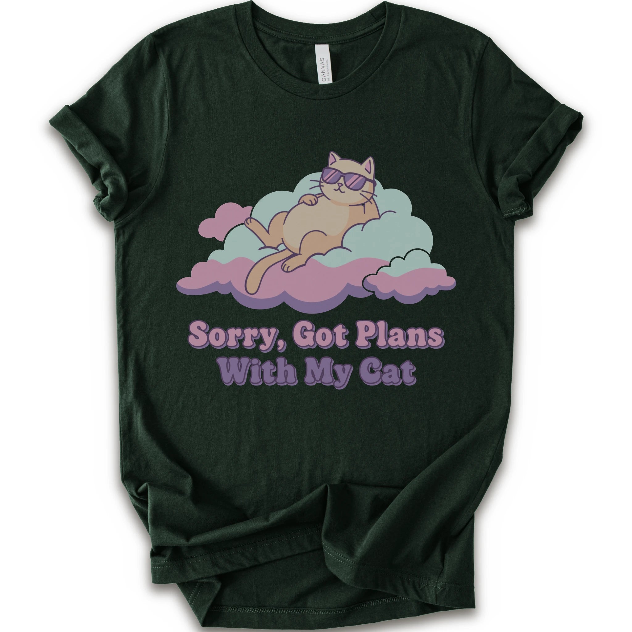 A forest short-sleeve t-shirt with a graphic of a sleeping orange cat wearing sunglasses on pink and light blue clouds, with the text 'Sorry, Got Plans With My Cat'.