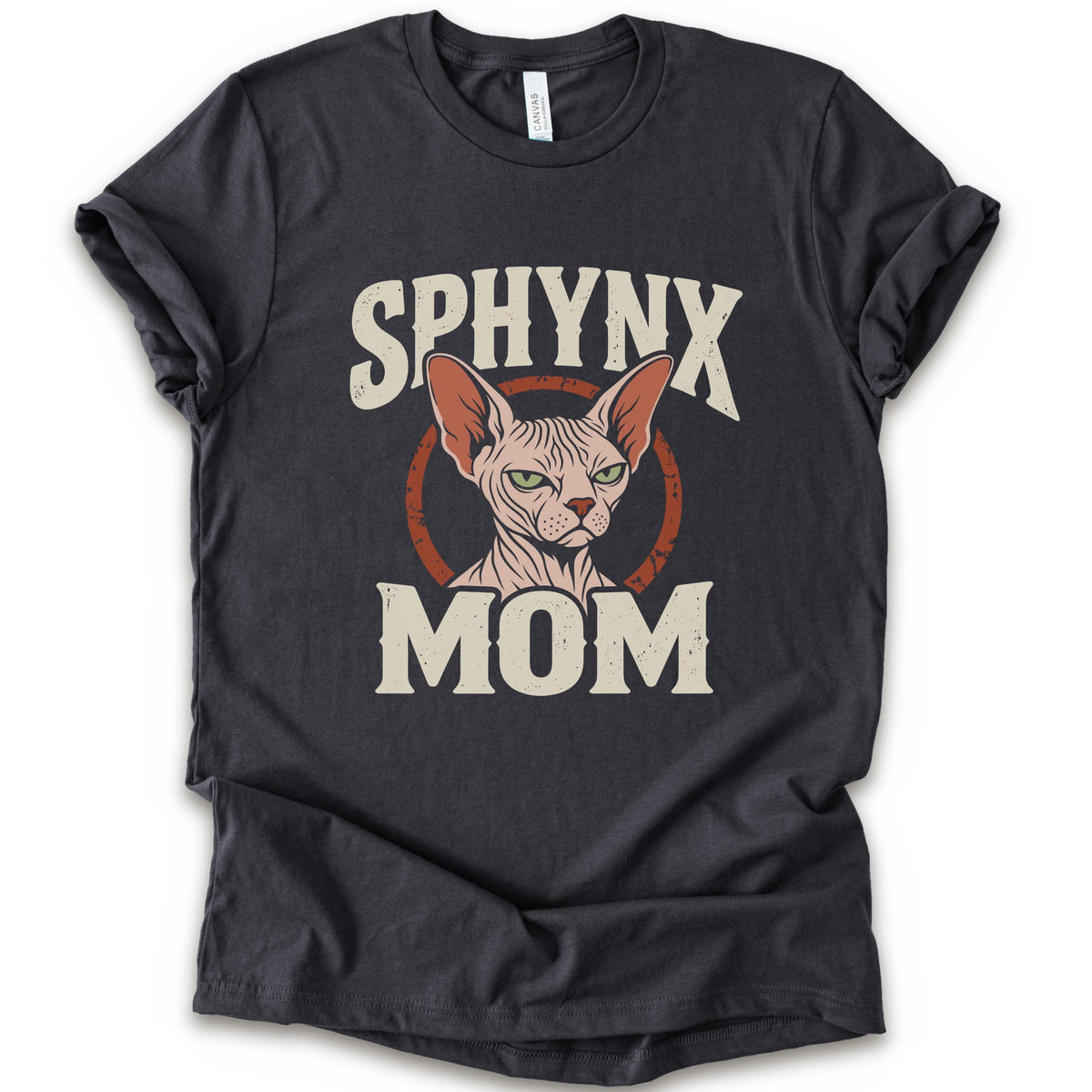 A dark grey short-sleeve crewneck t-shirt with a graphic print of a Sphynx cat and the text 'SPHYNX MOM' in distressed cream lettering.