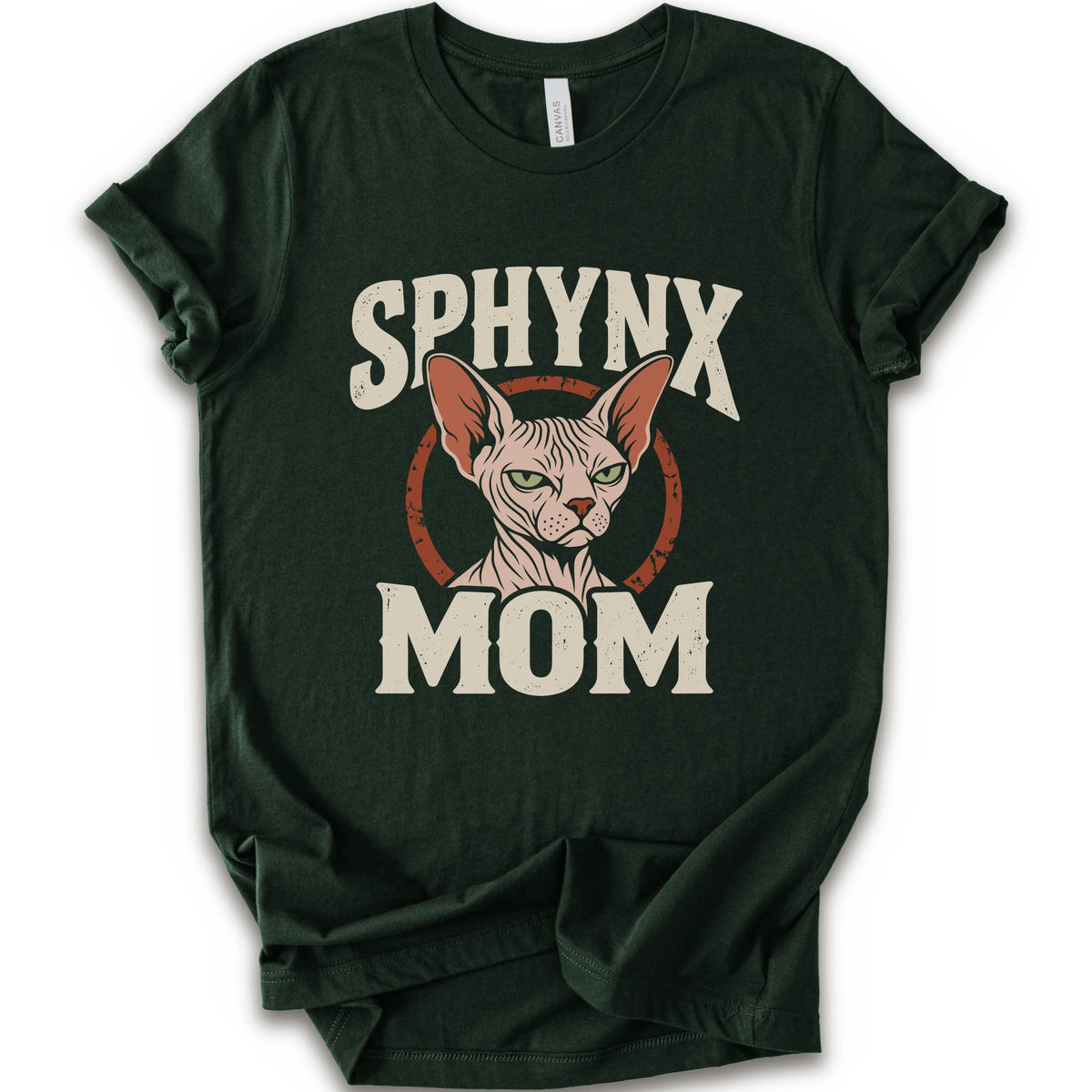 A forest short-sleeve crewneck t-shirt with a graphic print of a Sphynx cat and the text 'SPHYNX MOM' in distressed cream lettering.