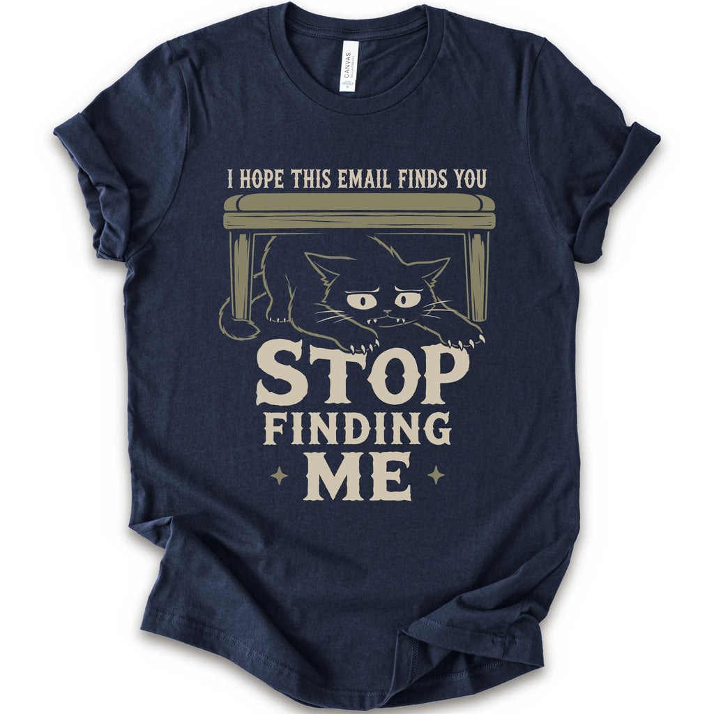 Navy graphic t-shirt  with a black cat crouching under a desk with “I Hope This Email Finds You” and “Stop Finding Me” distressed text