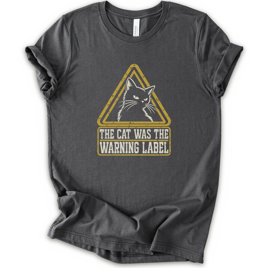 An asphalt short-sleeve crewneck t-shirt with a distressed yellow and white graphic on the front showing a cat inside a warning triangle and the text 'THE CAT WAS THE WARNING LABEL'.
